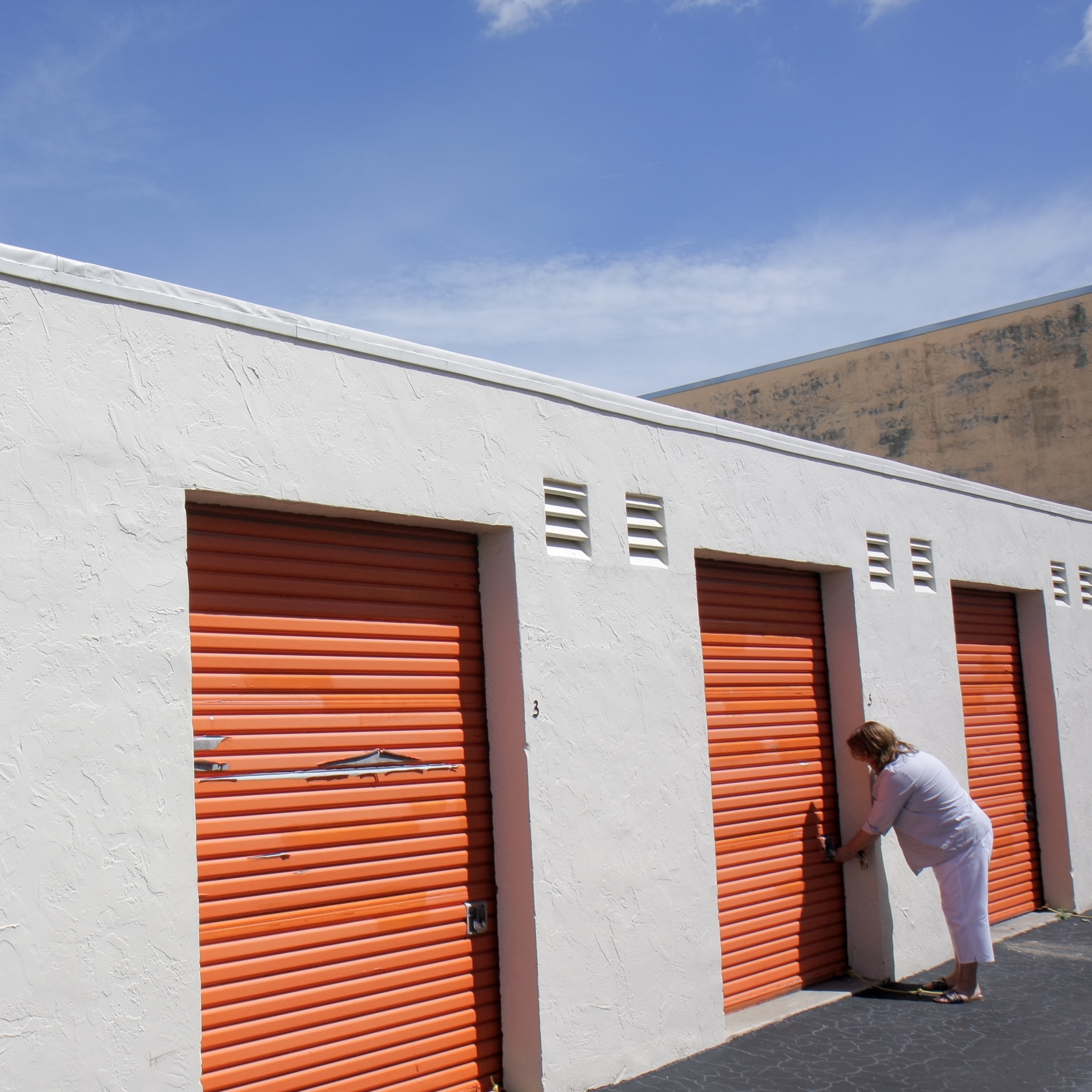 A woman unlocking a unit at Public Storage.