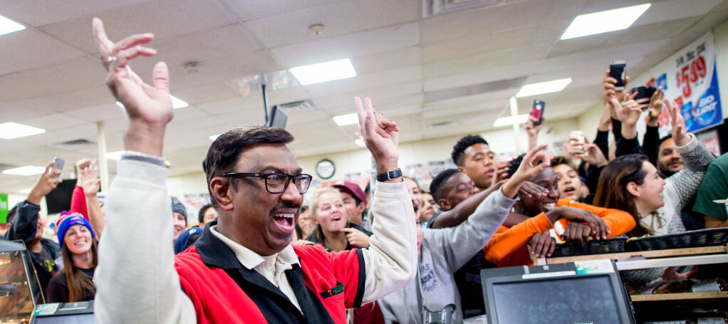 7-11 worker celebrates after selling winning Powerball ticket