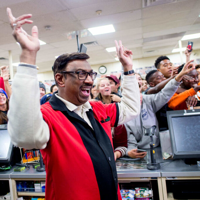 7-11 worker celebrates after selling winning Powerball ticket