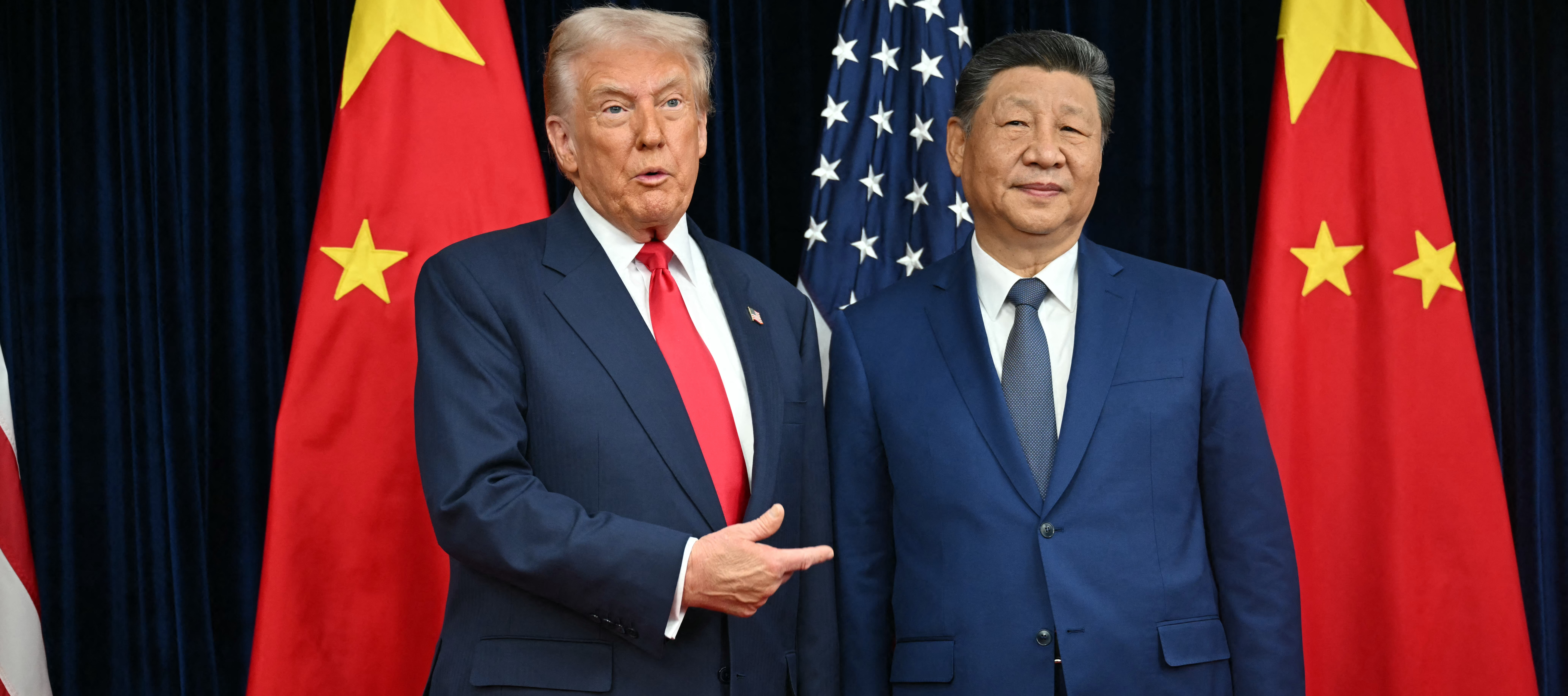 President Trump poses for photos with Chinese President Xi Jinping.