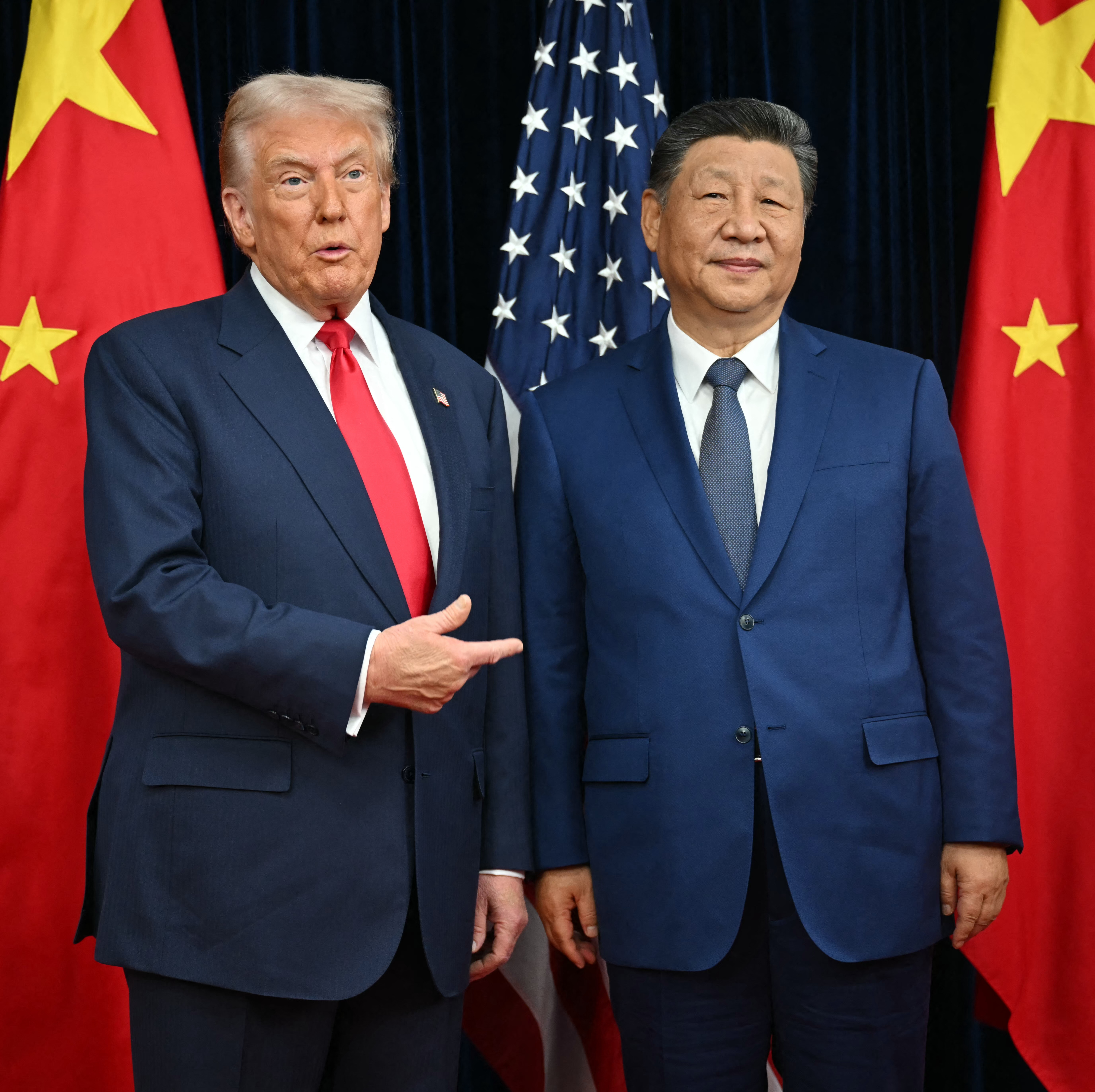 President Trump poses for photos with Chinese President Xi Jinping.