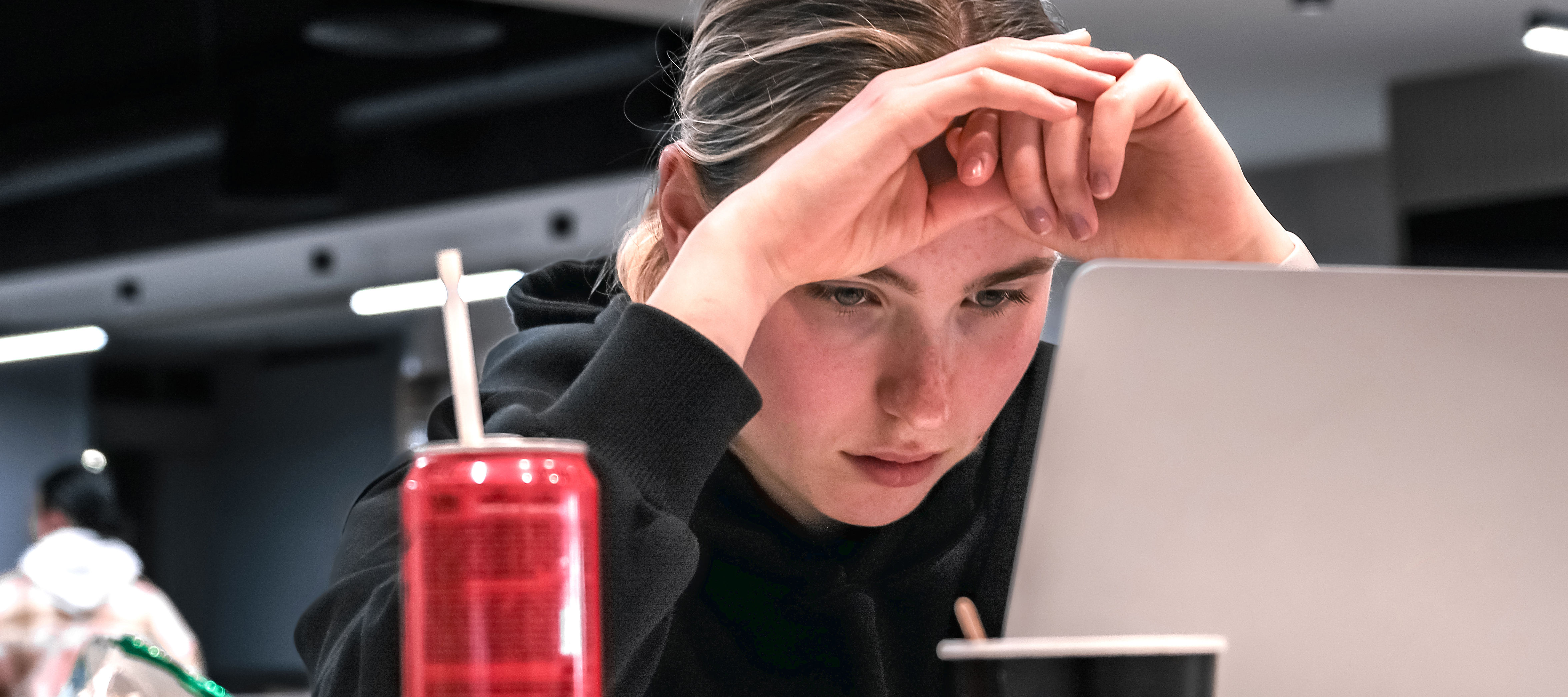Students, like the young woman seen here in front of a laptop, are increasing moving away from computer science as AI continues to disrupt the field.