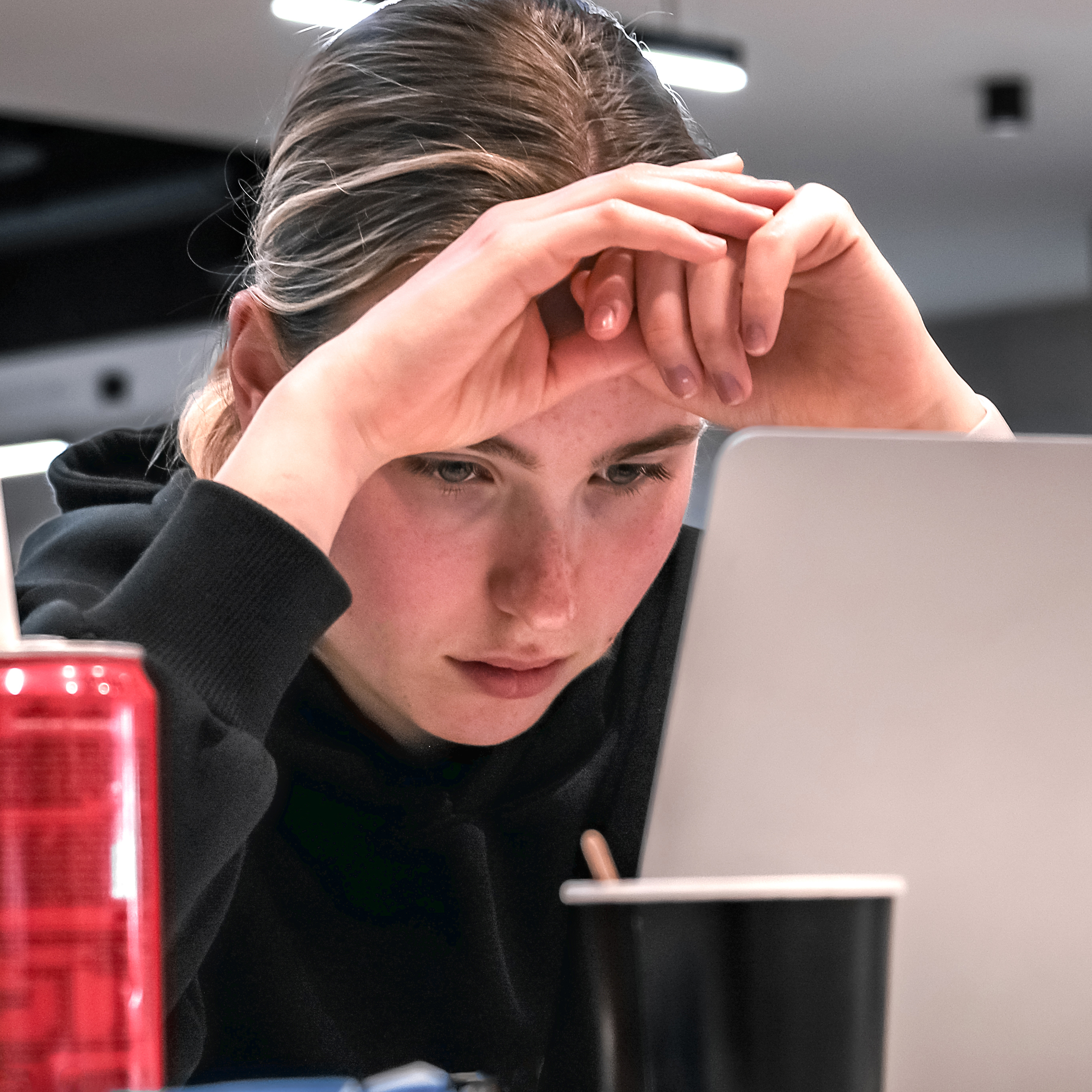 Students, like the young woman seen here in front of a laptop, are increasing moving away from computer science as AI continues to disrupt the field.