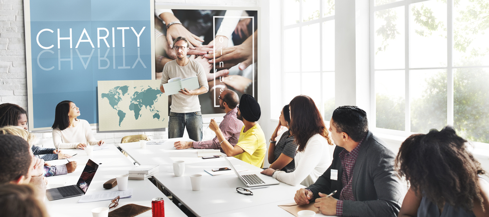 Photo of a room of people in a charity-focused meeting