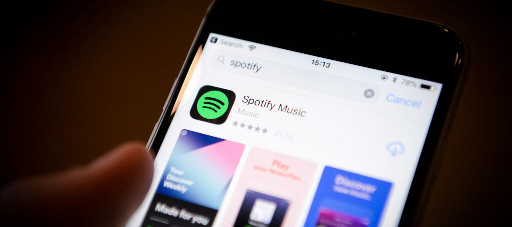 A photo of a smartphone with the Spotify app showing in the App Store