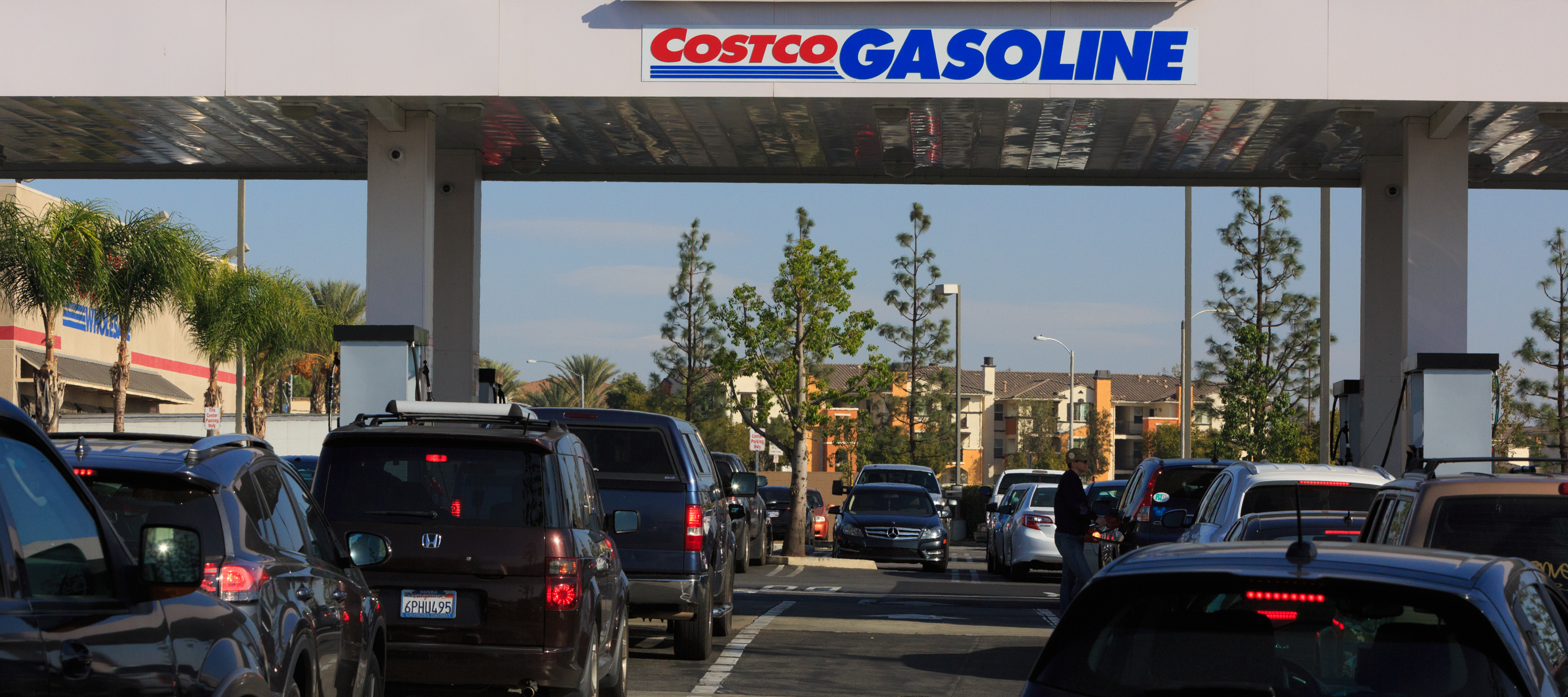 Cars line up to refuel at a Costco gas station.