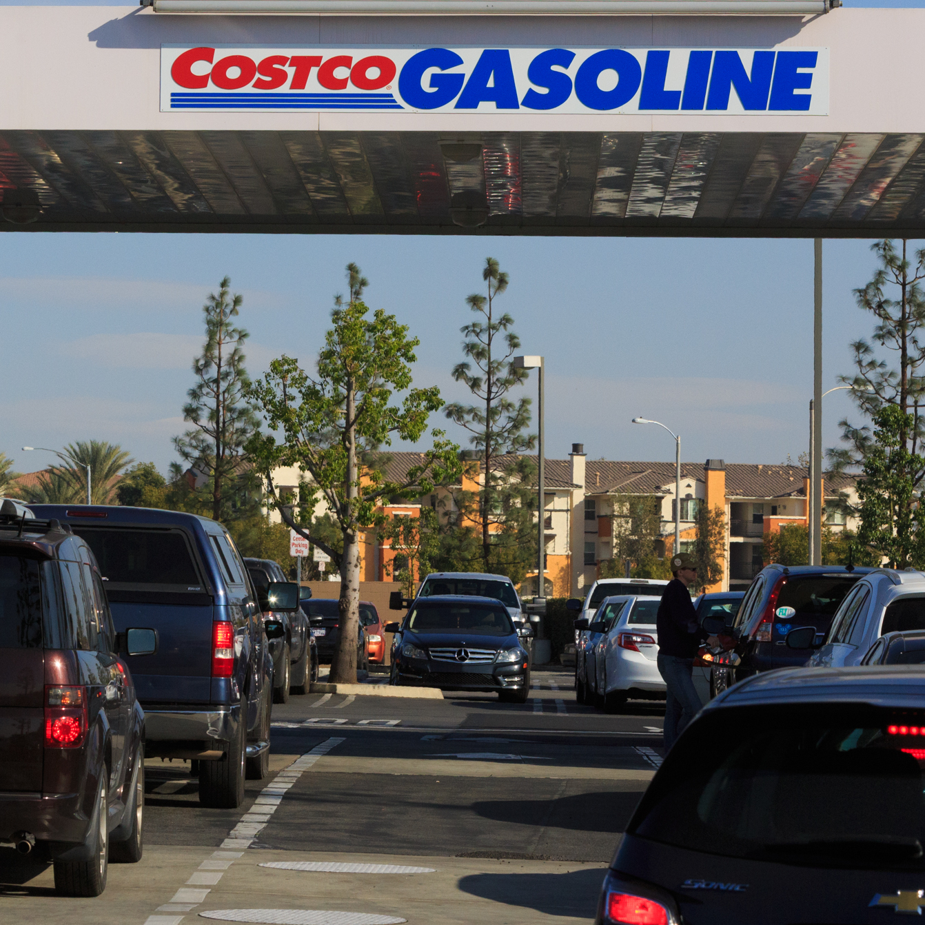 Cars line up to refuel at a Costco gas station.