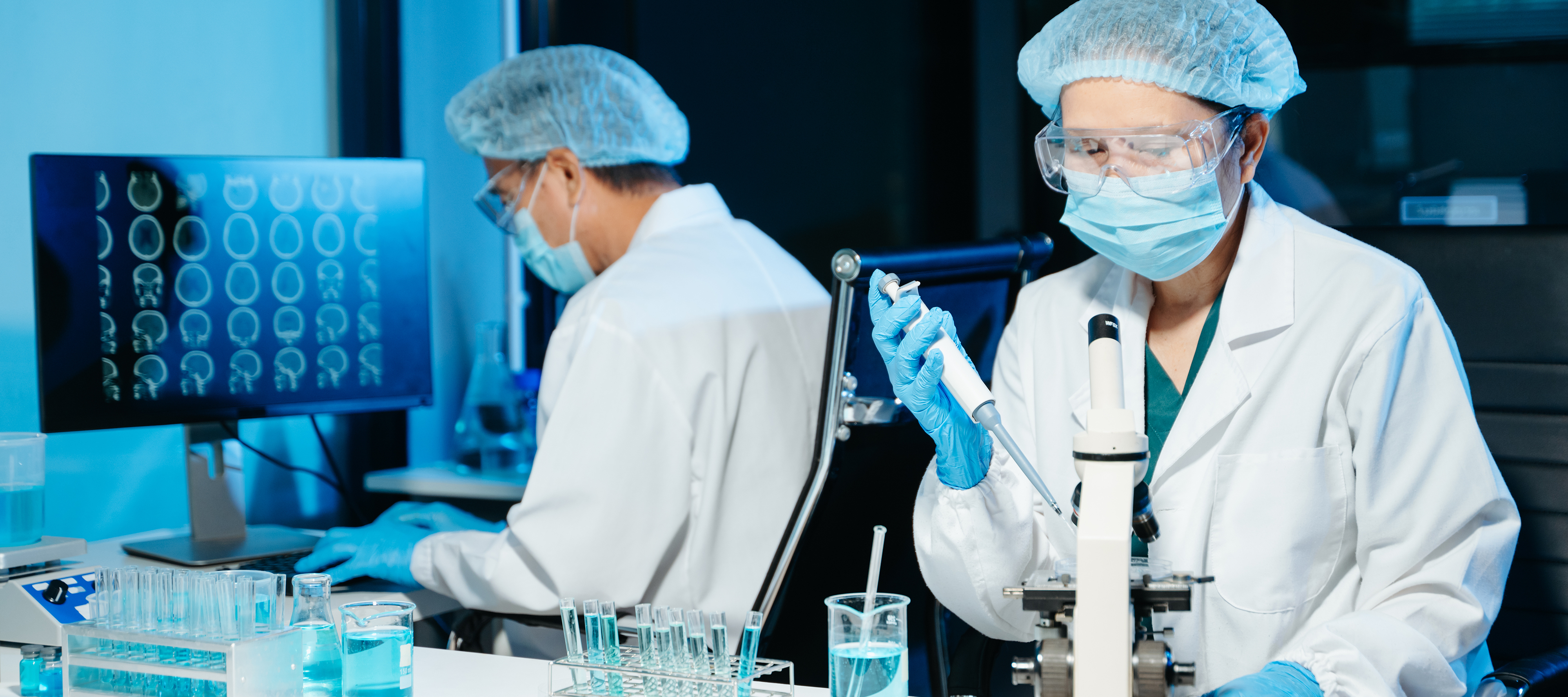 Scientists run tests in a lab.