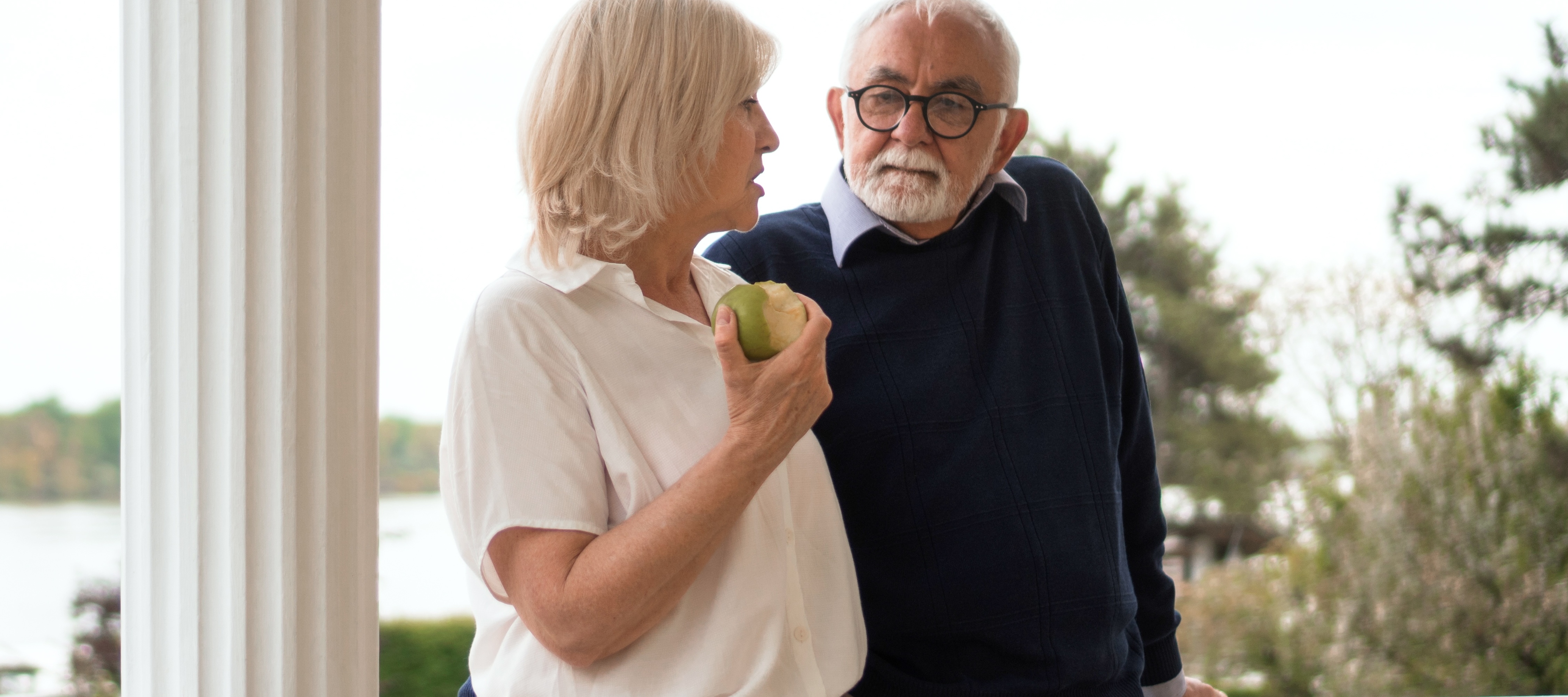 Pensive senior couple chatting outside
