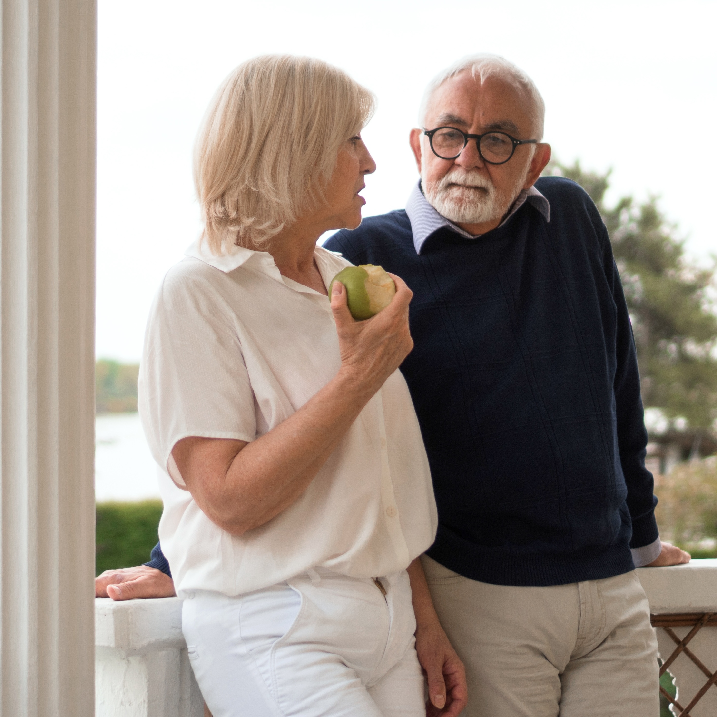Pensive senior couple chatting outside