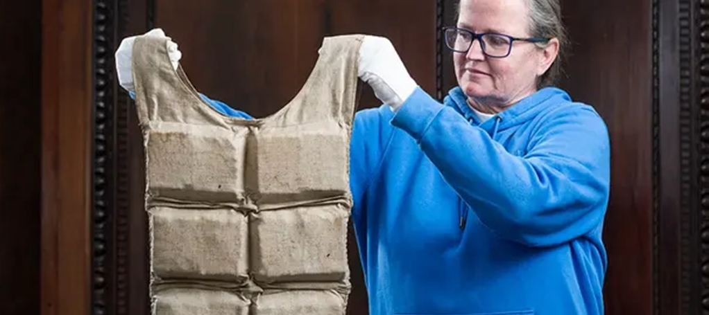 A member of the Henry Aldridge and Son staff holds up the Titanic life jacket that was auctioned off.