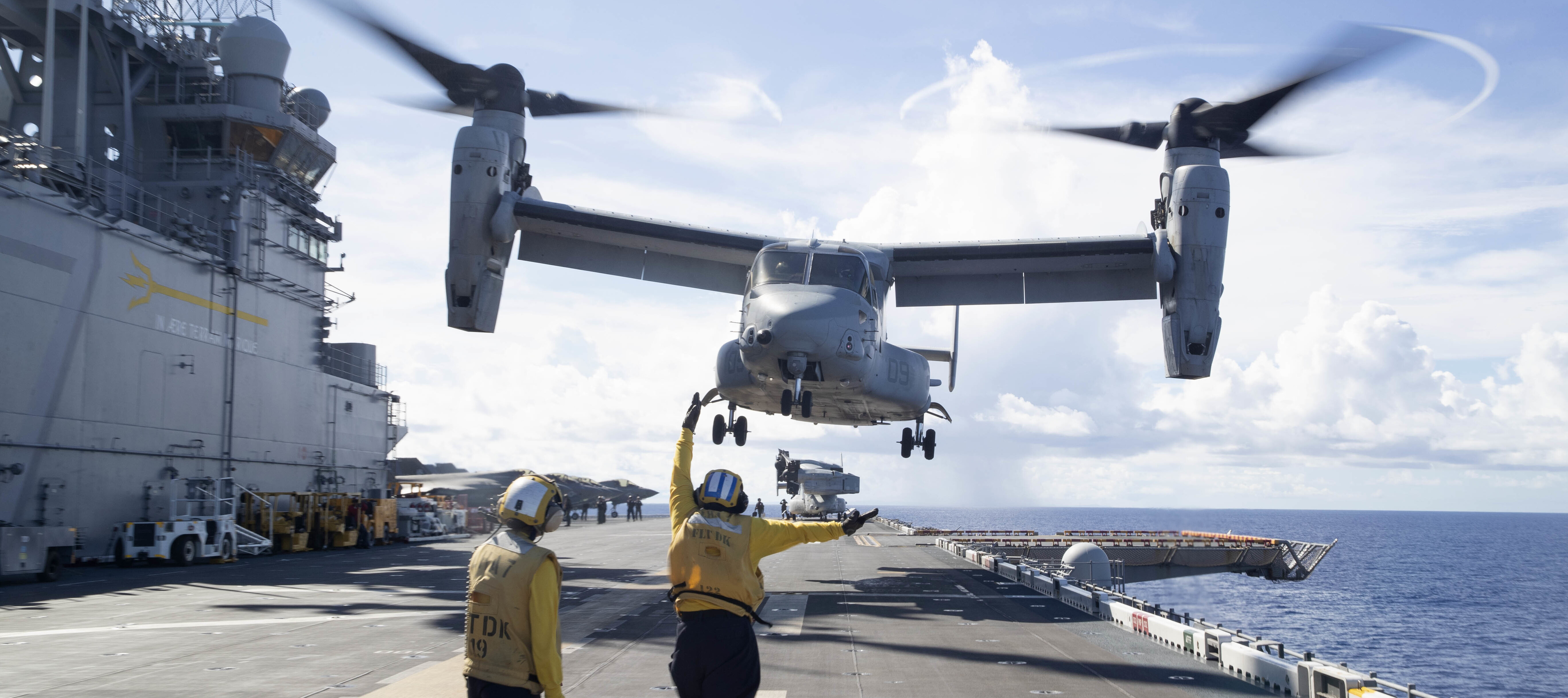 Crew aboard amphibious assault ship USS Tripoli carries out airborne exercises.