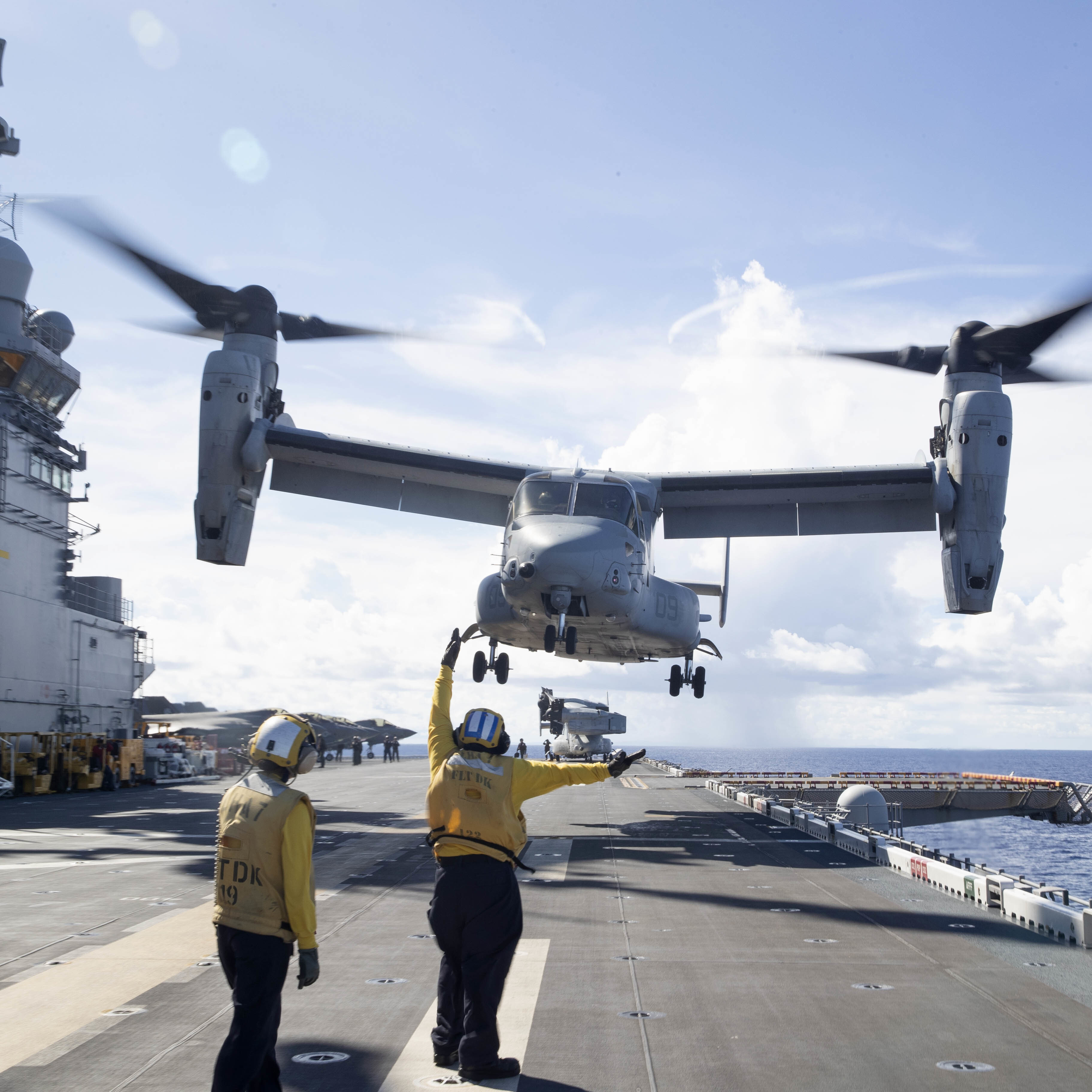 Crew aboard amphibious assault ship USS Tripoli carries out airborne exercises.
