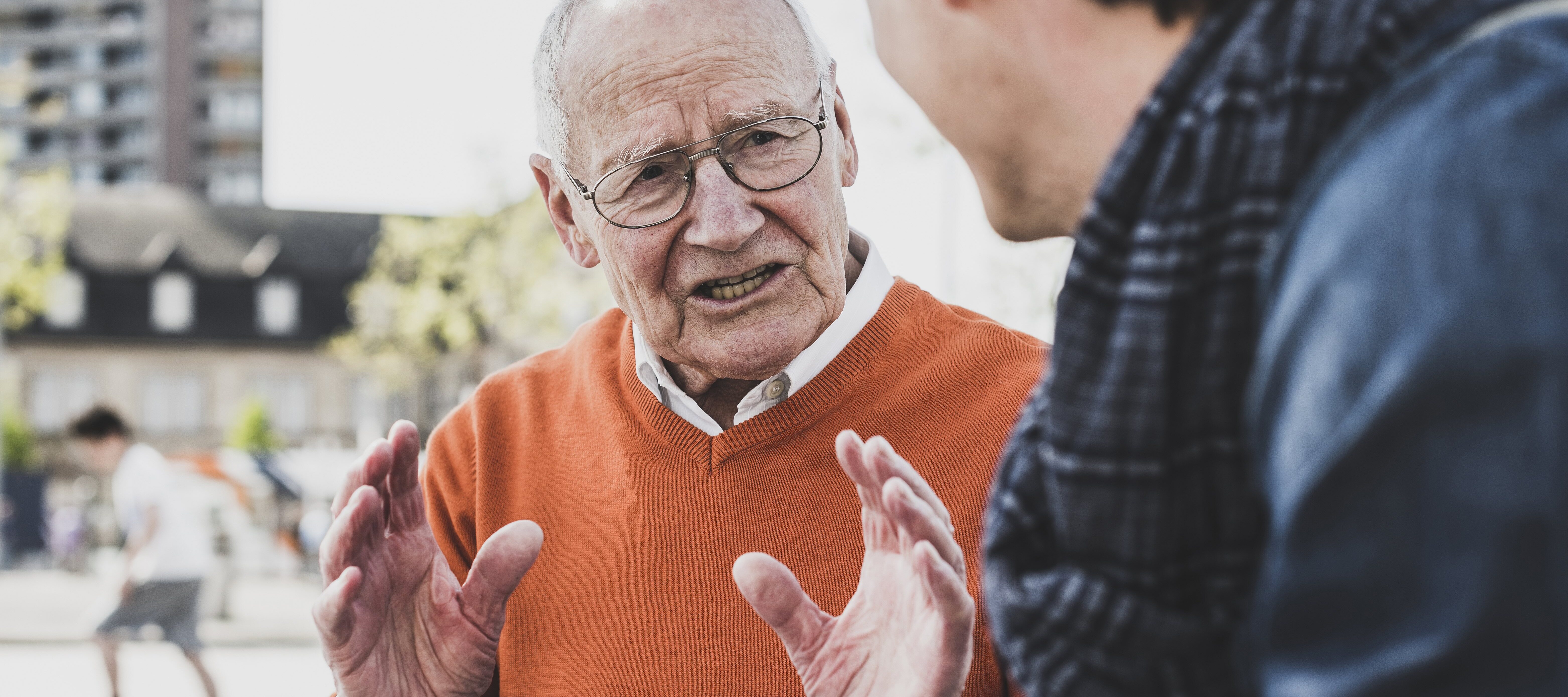 Older man disagreeing with younger man