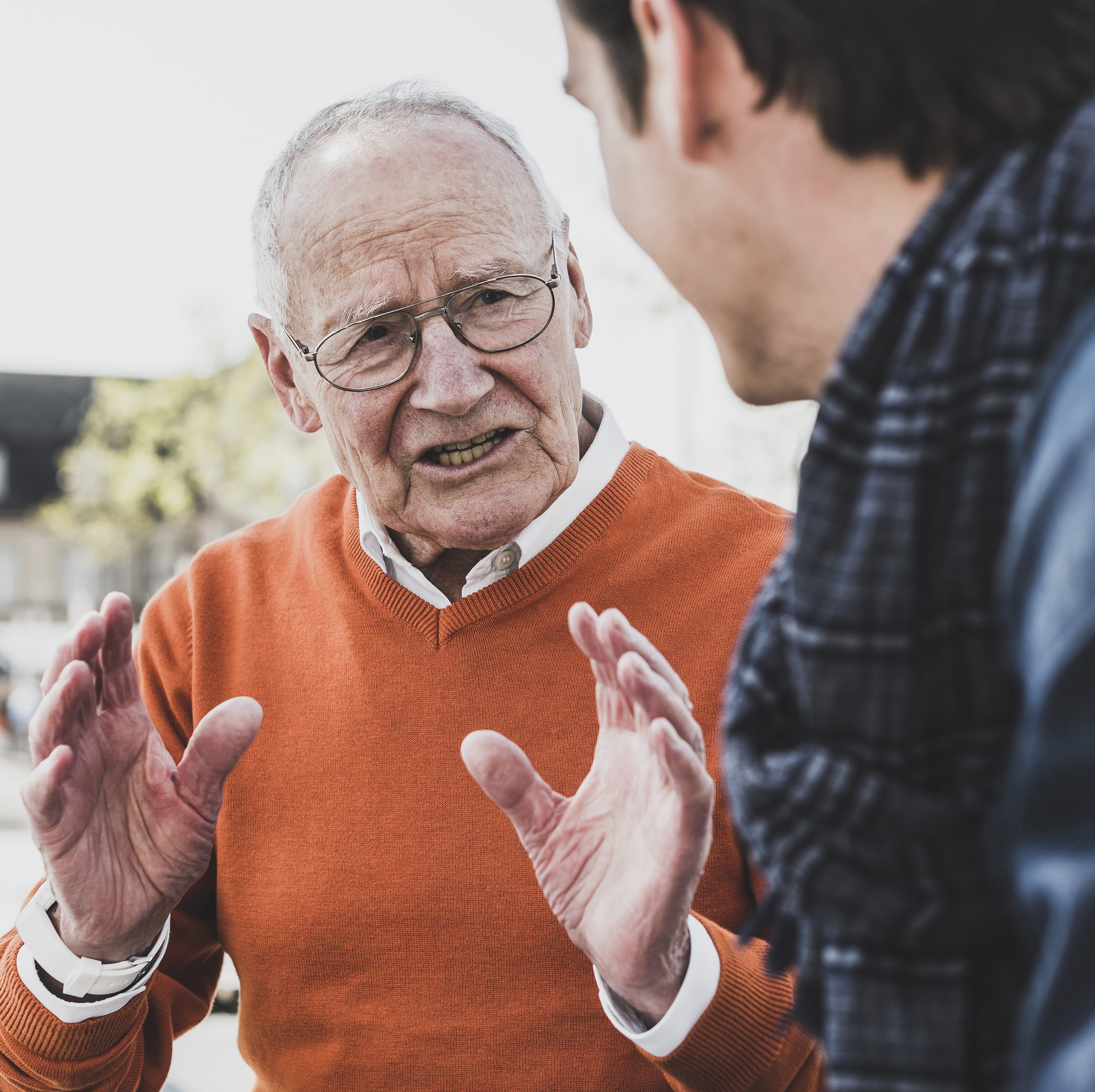 Older man disagreeing with younger man