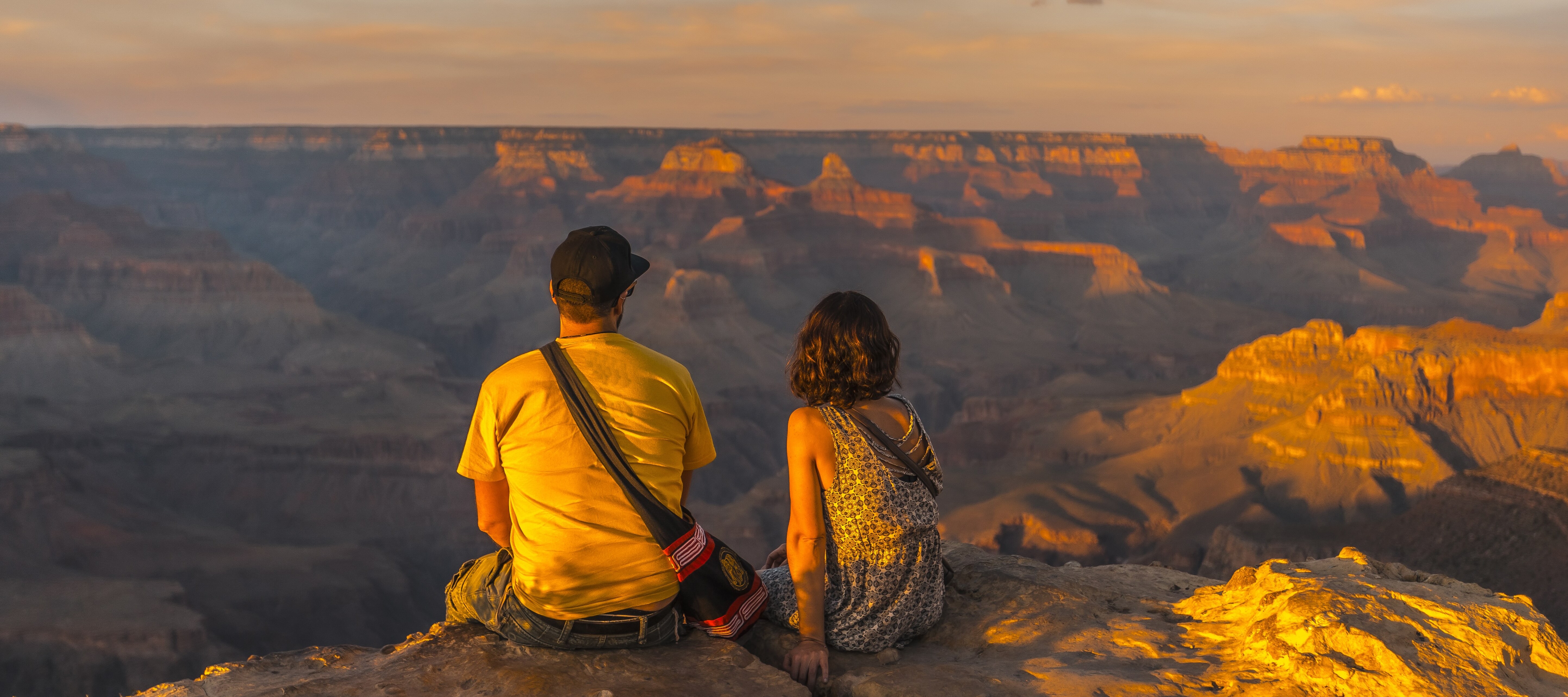 Young couple watching the sunset at Grand Canyon