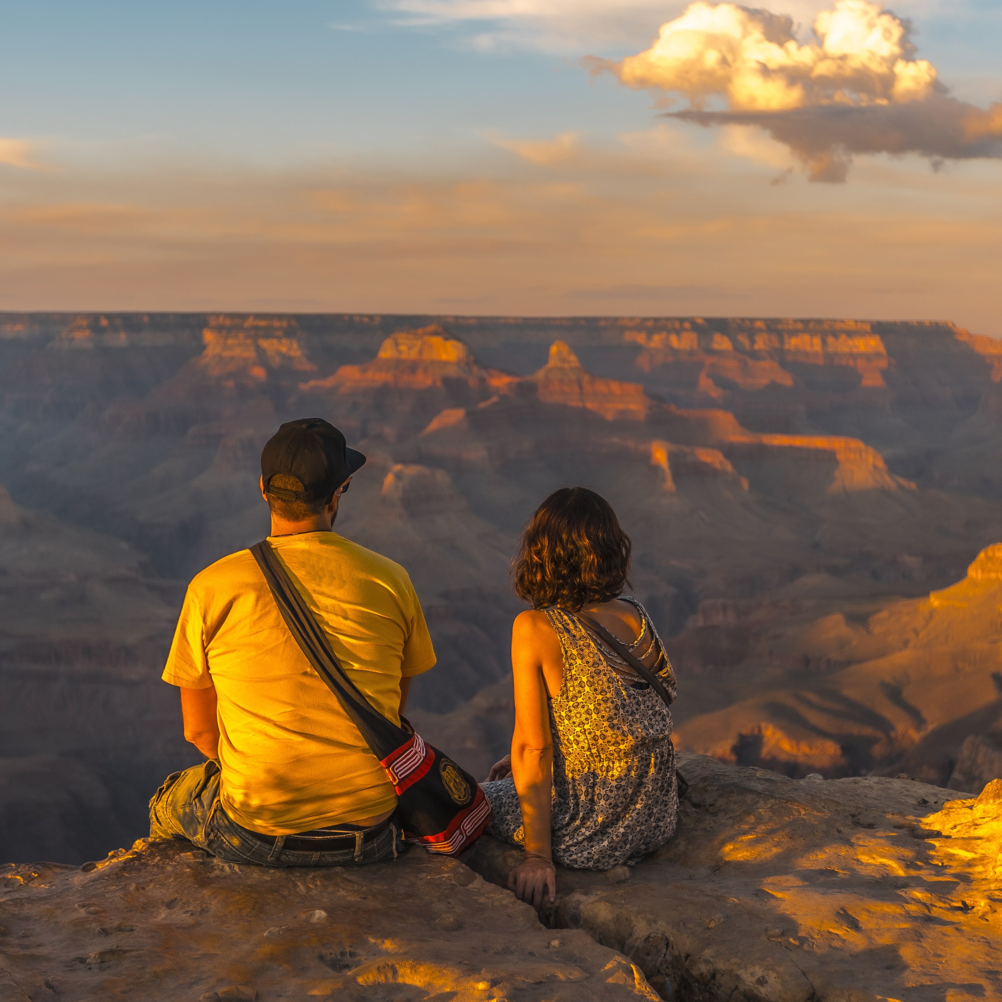 Young couple watching the sunset at Grand Canyon