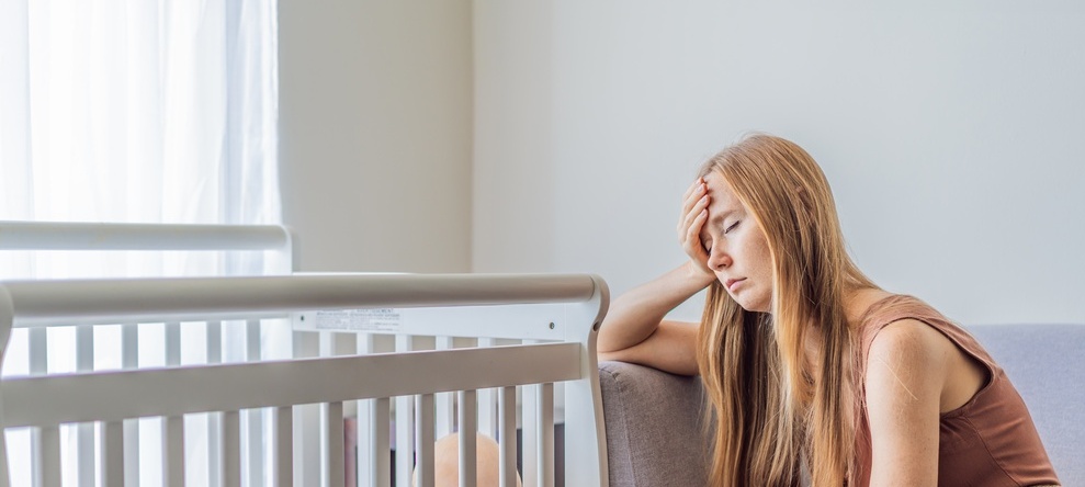 Photo of a stressed mother with baby