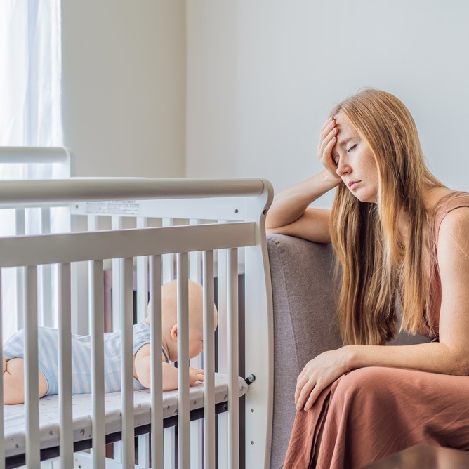 Photo of a stressed mother with baby