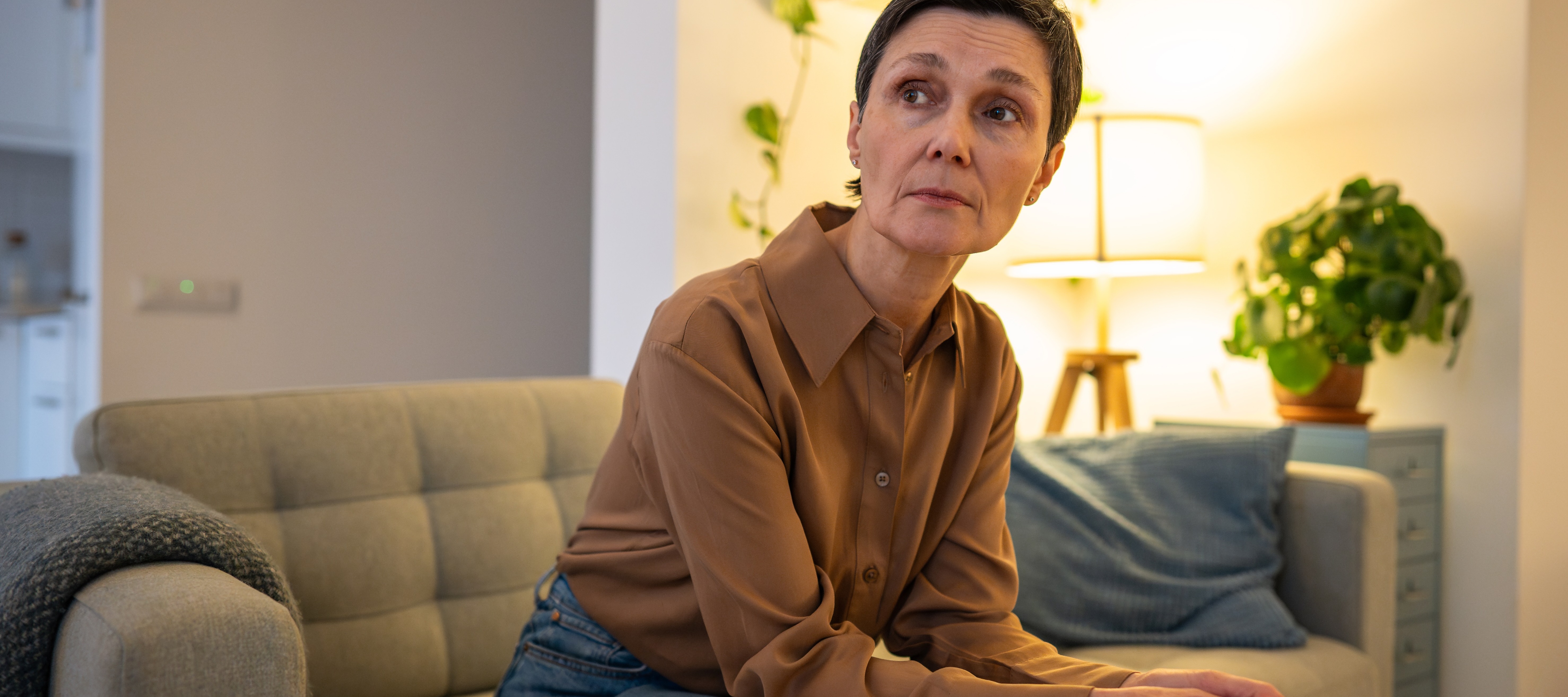65-year-old woman sitting in her living room