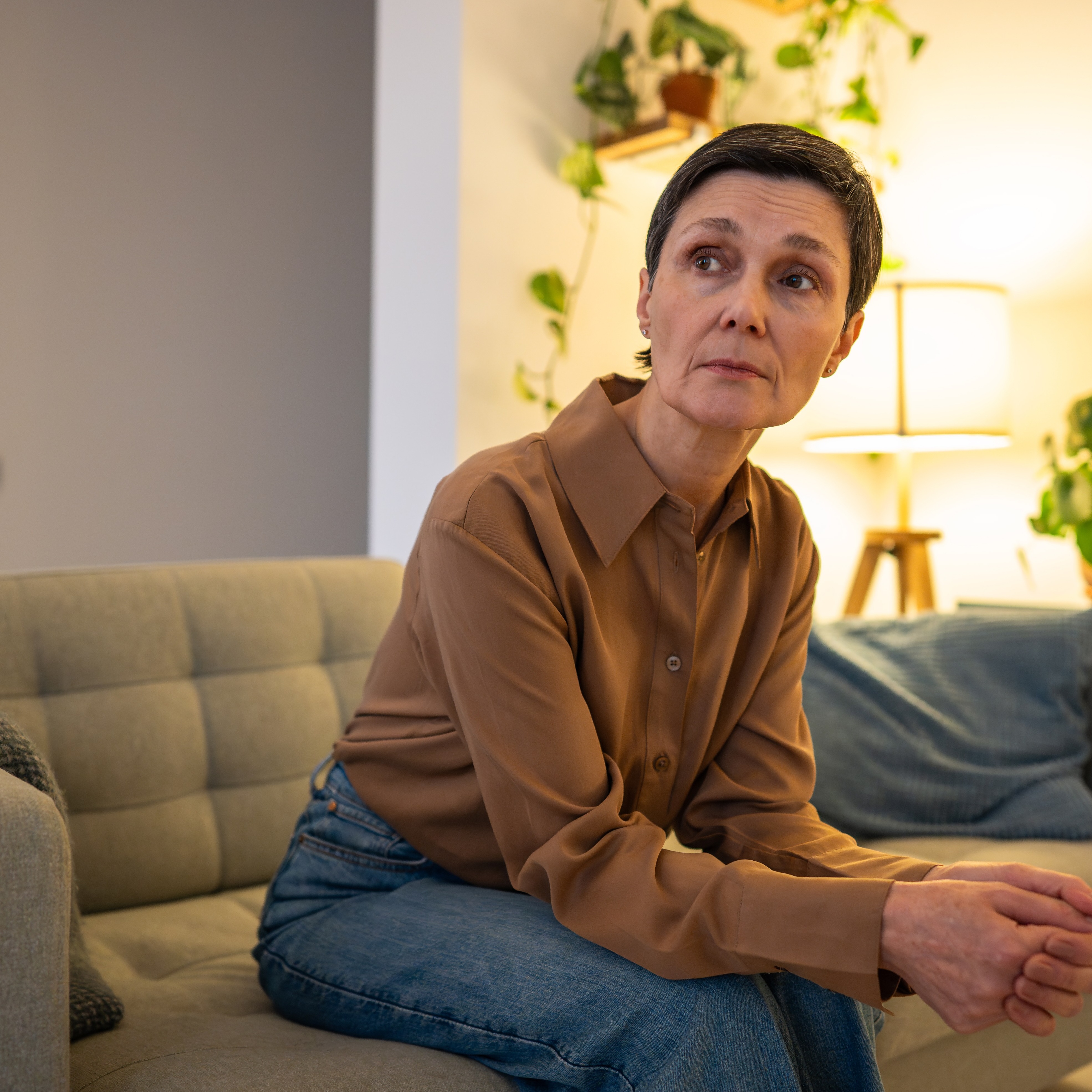 65-year-old woman sitting in her living room