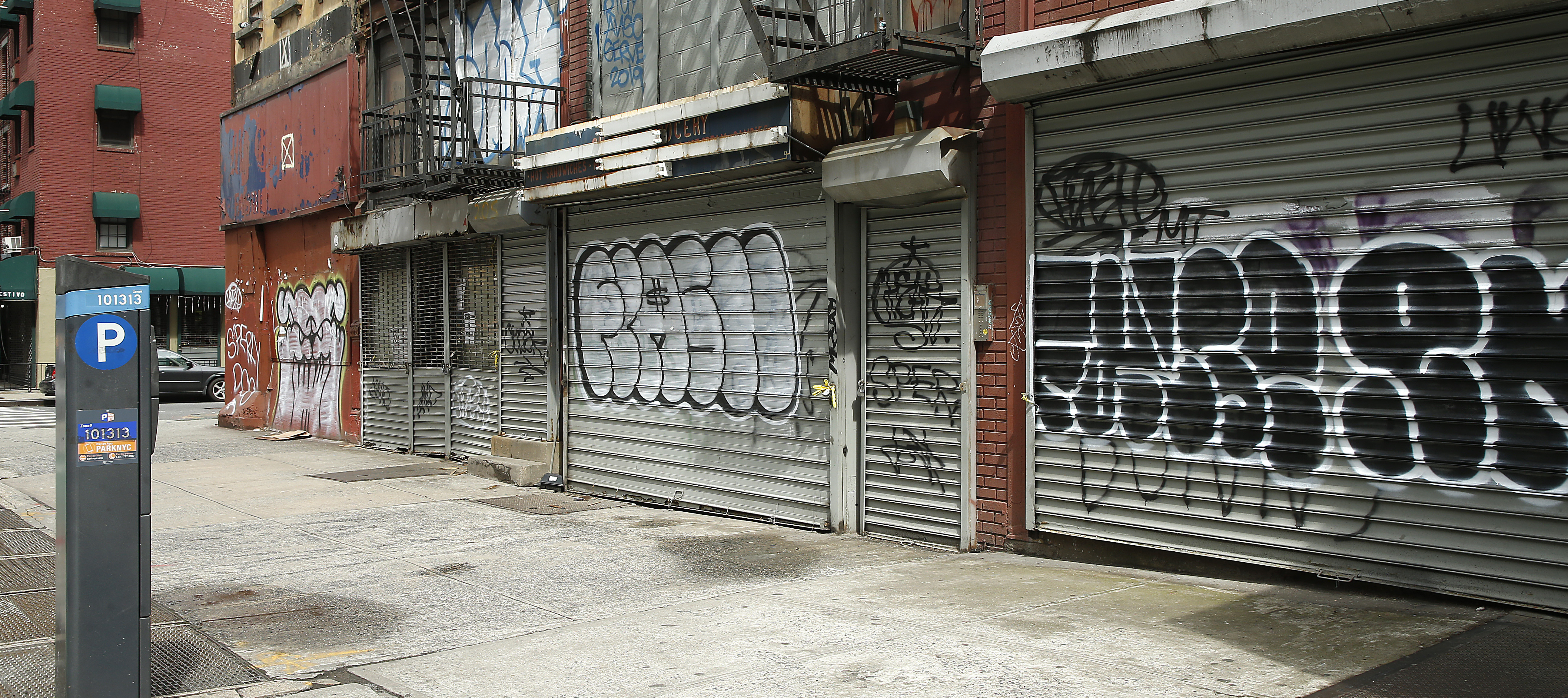 Small businesses in New York City with their security gates rolled down.