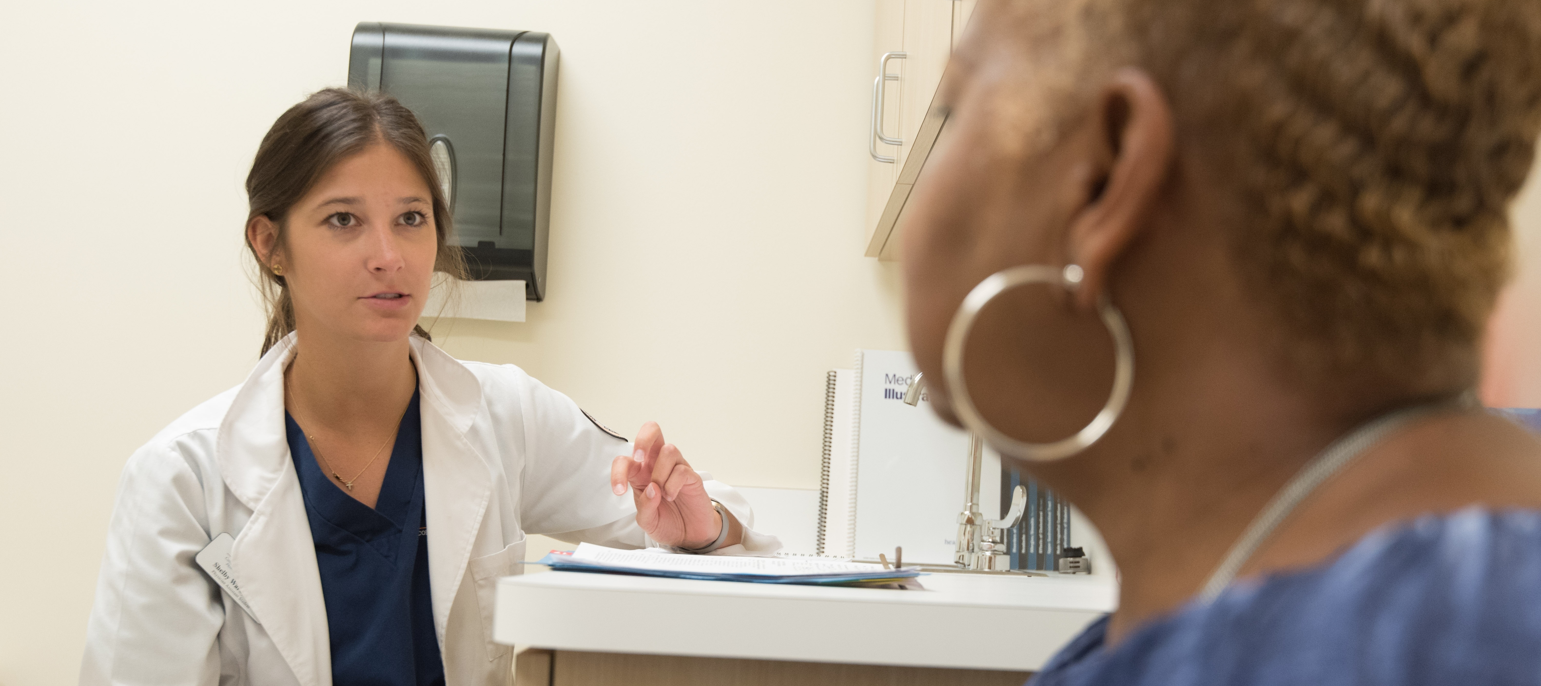 A doctor speaks with one of her patients.
