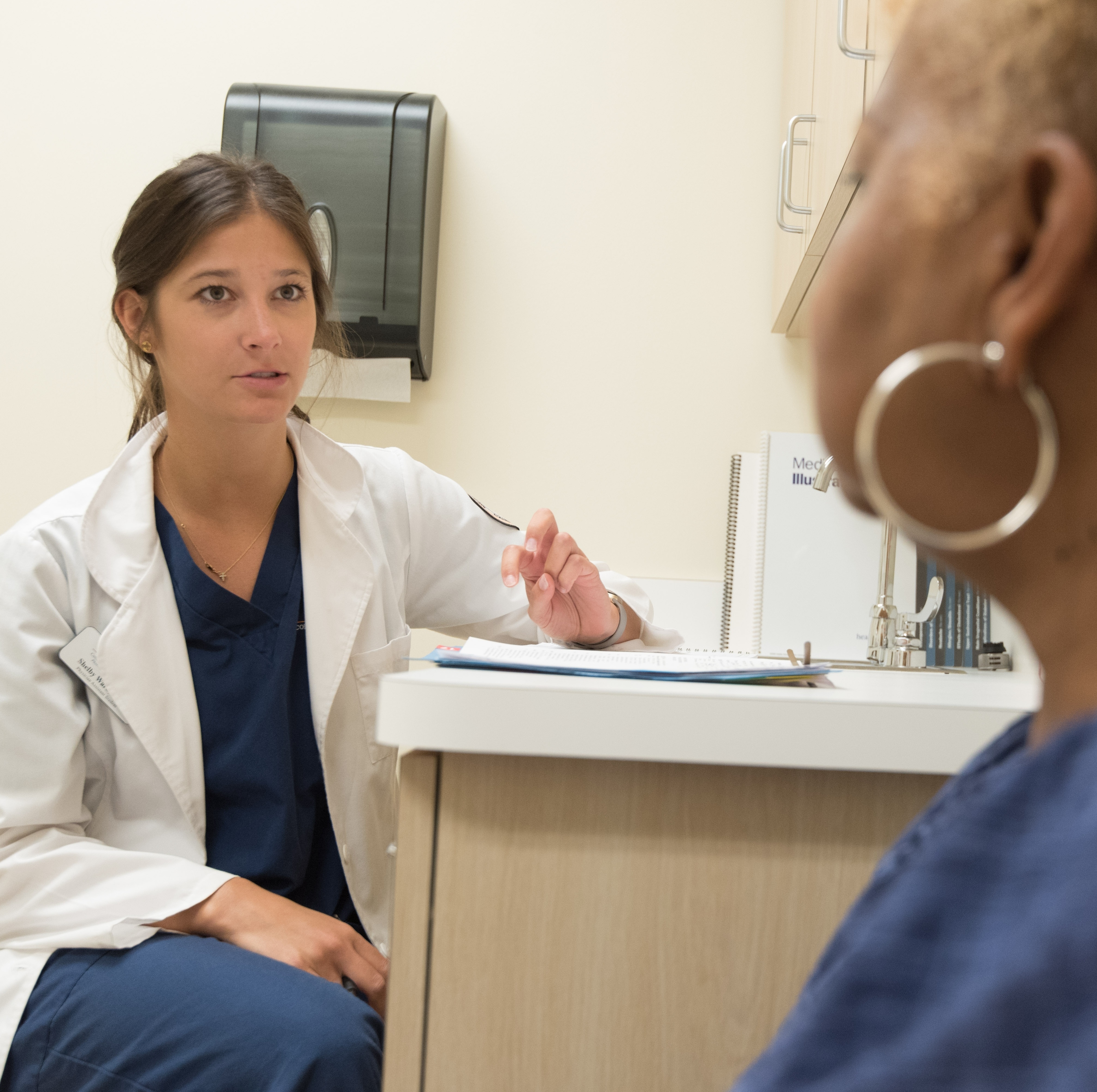 A doctor speaks with one of her patients.