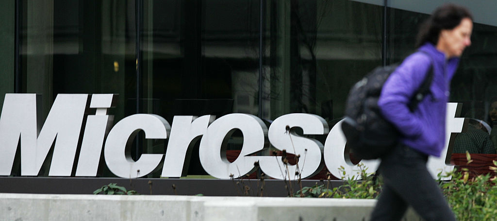 A photo of a woman walking past a Microsoft office