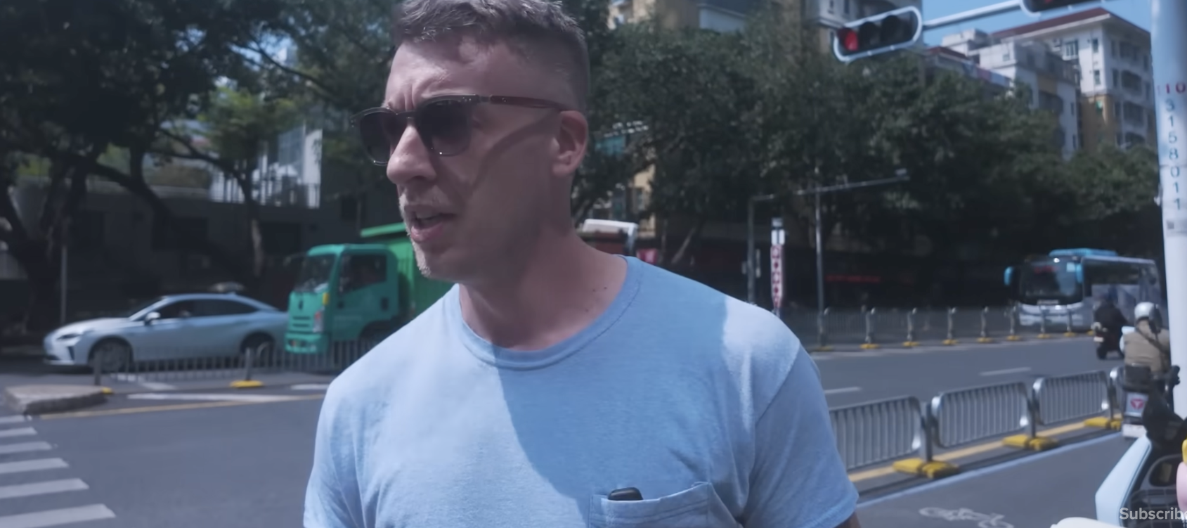 Bradley Krae, seen here walking along a street in Shenzhen, says moving to China has saved him three-quarters of the cost of living in the U.S.