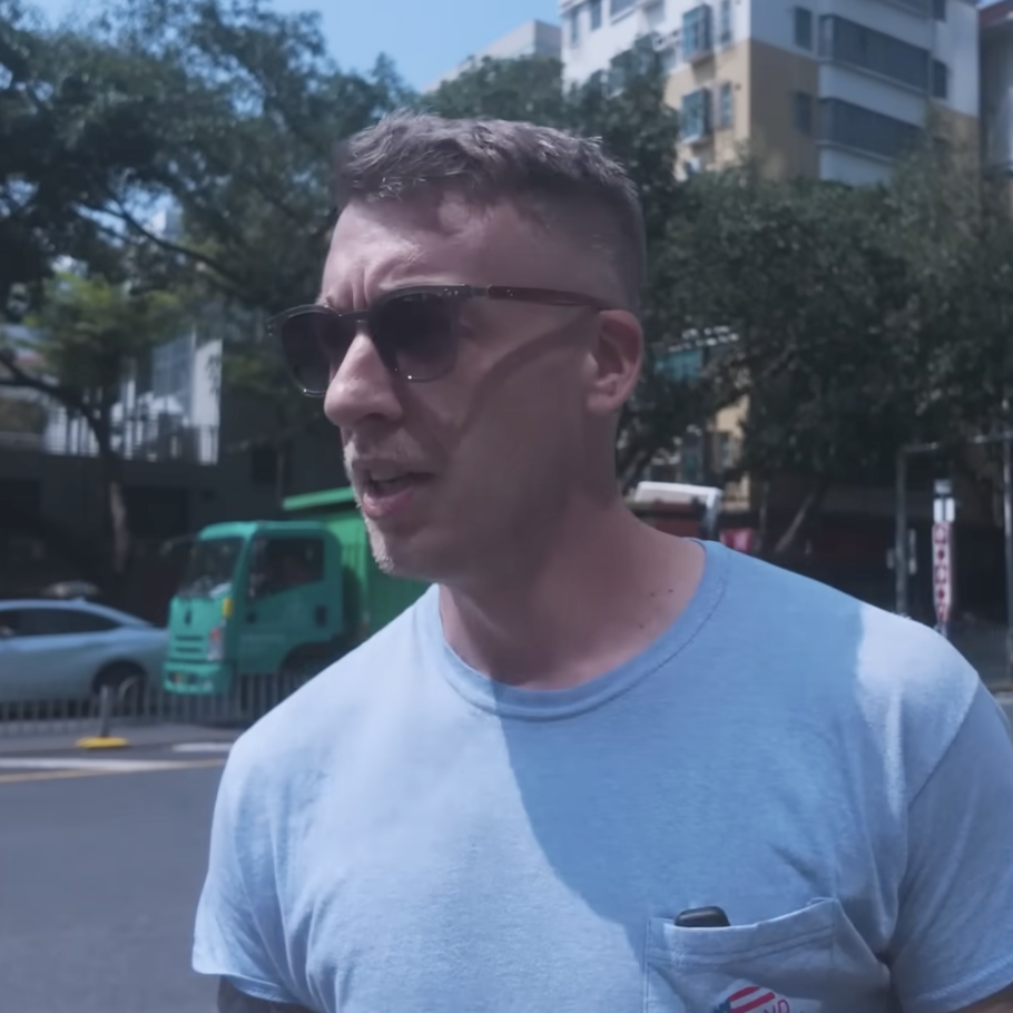 Bradley Krae, seen here walking along a street in Shenzhen, says moving to China has saved him three-quarters of the cost of living in the U.S.
