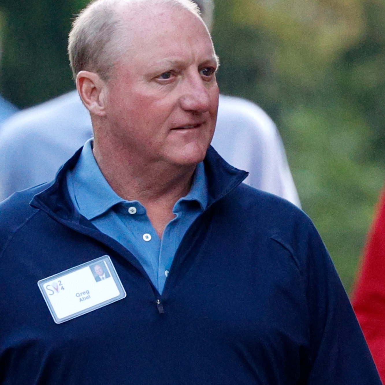 On the left Greg Abel is walking outside, on the right Warren Buffet speaks into a microphone