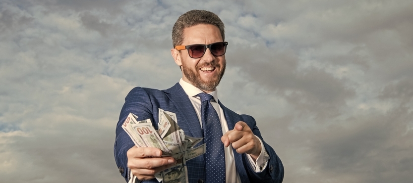 Photo of a man with a wad of cash