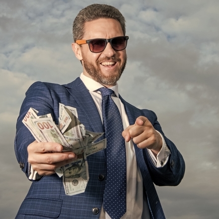 Photo of a man with a wad of cash