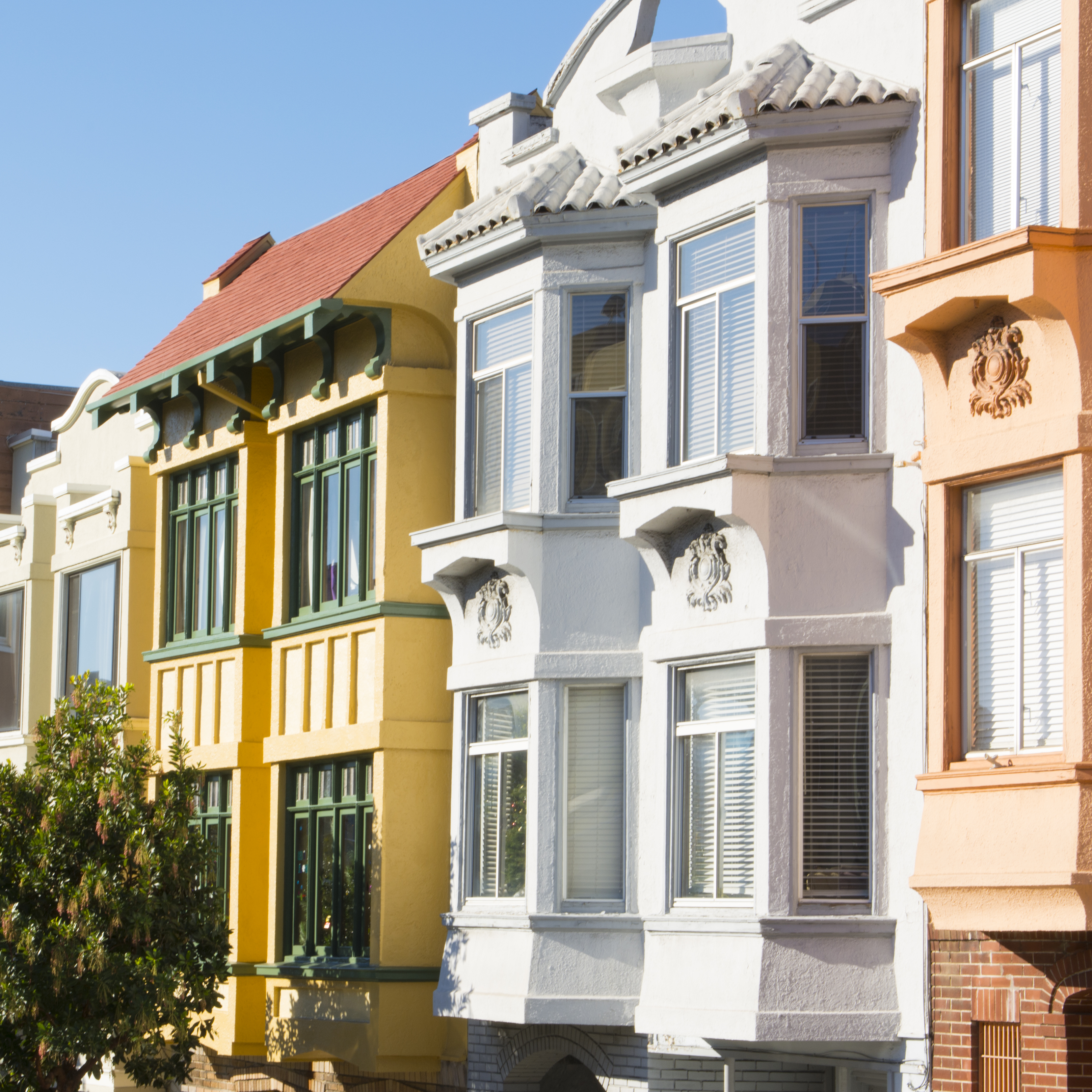 San Francisco California Russian Hill colorful Victorian houses on Hyde and Broadway Streets in sunshine with abstract windows.