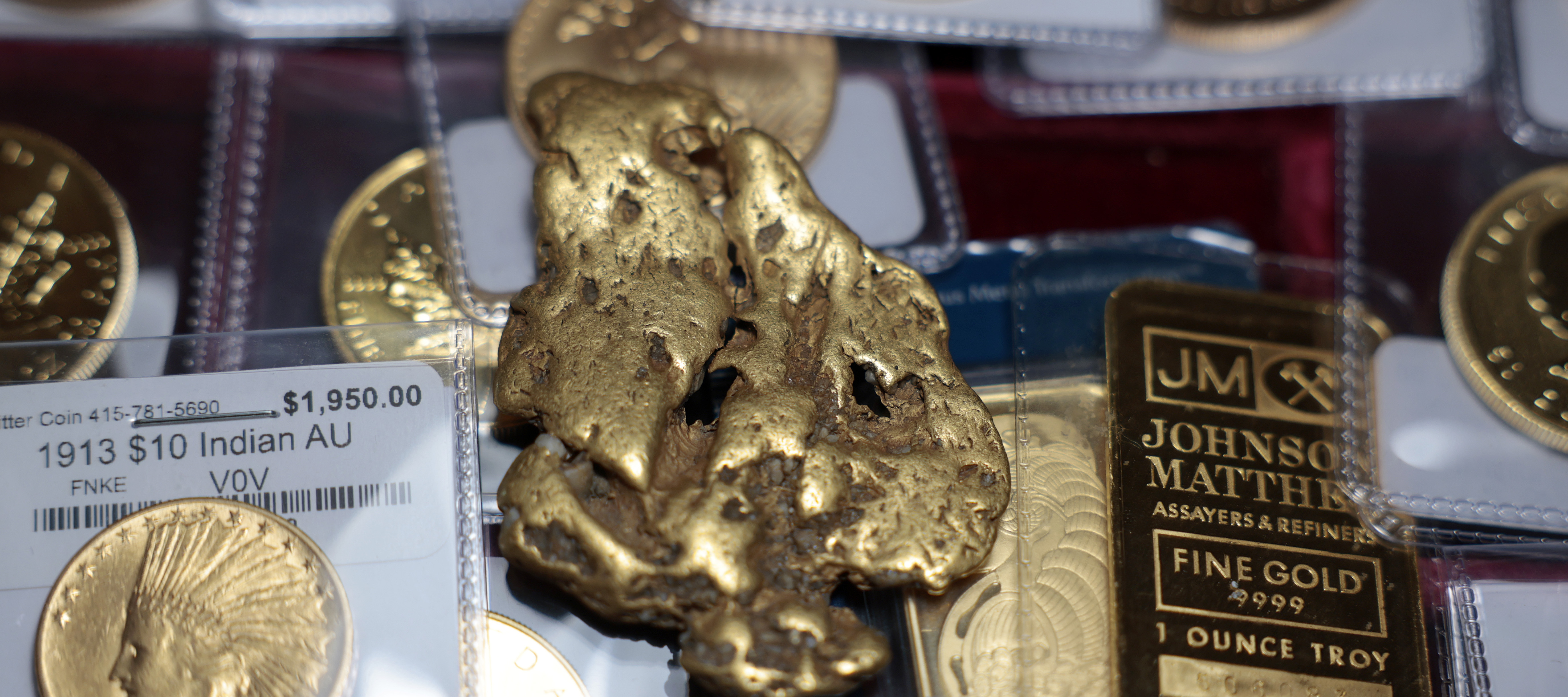 a one-ounce gold bar, a gold nugget, and gold coins are displayed at Witter Coins on October 07, 2025 in San Francisco, California.