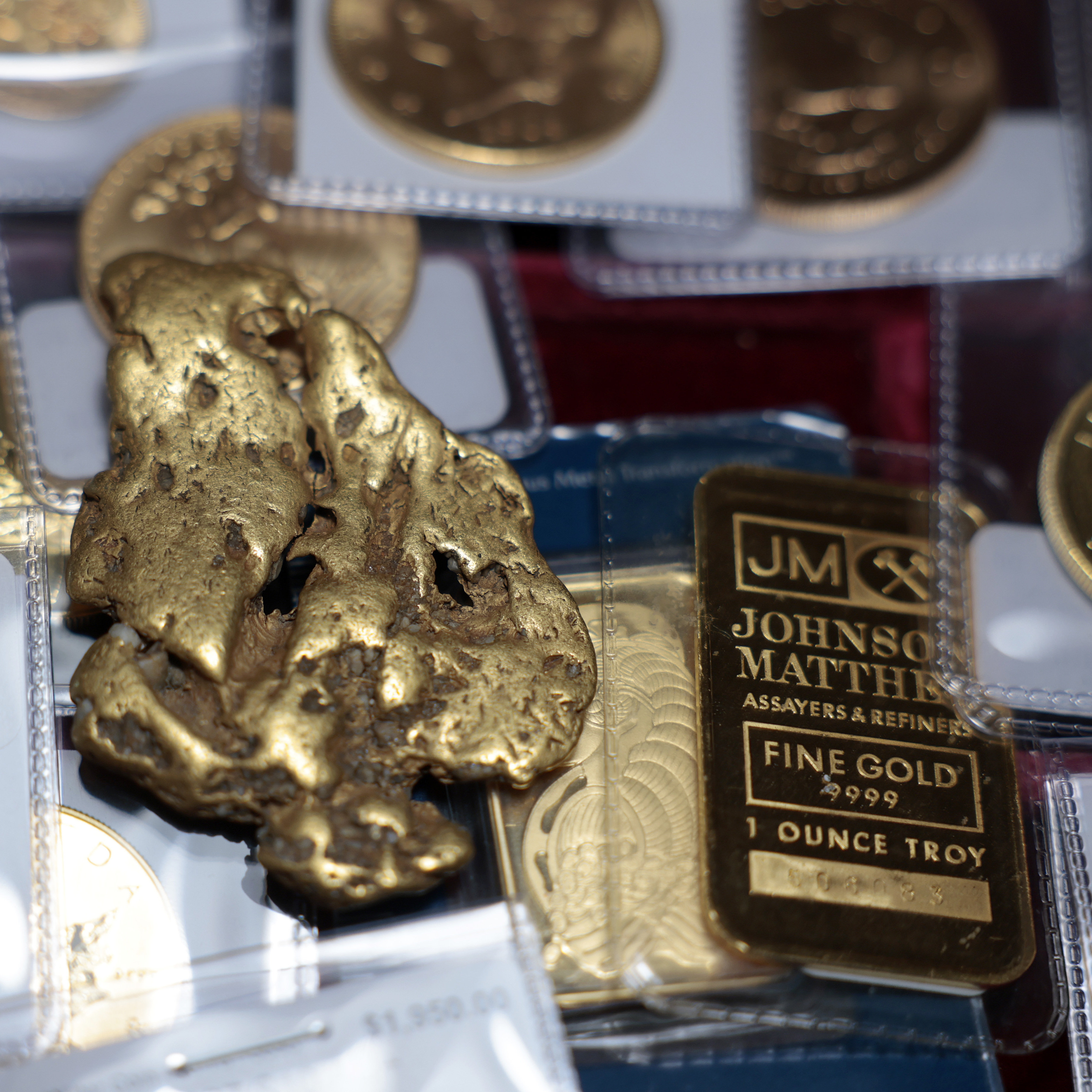 a one-ounce gold bar, a gold nugget, and gold coins are displayed at Witter Coins on October 07, 2025 in San Francisco, California.