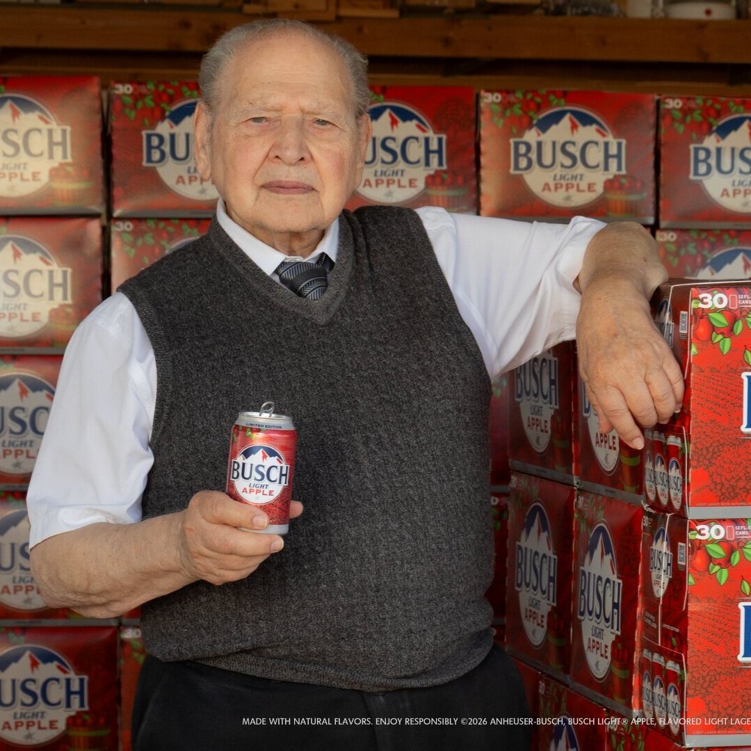 A photo of Apple co-founder Ronald Wayne with limited edition apple lager from Anheuser-Busch