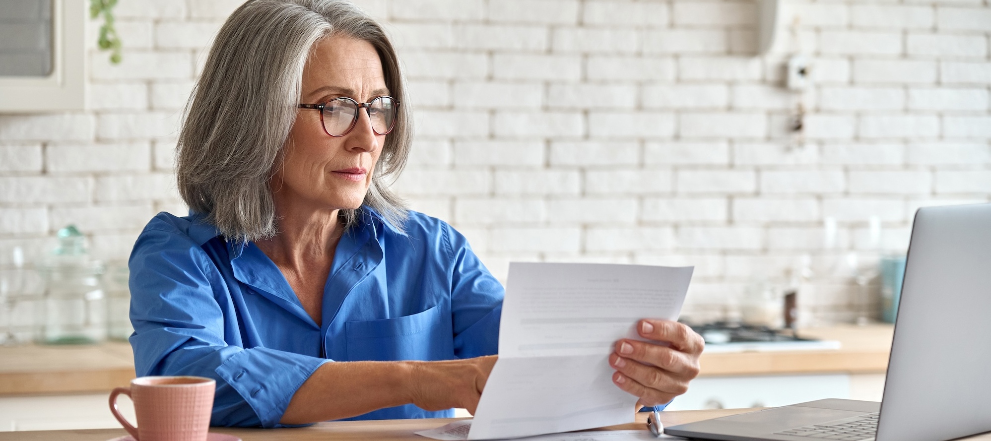 A middle-aged woman reviewing her finances