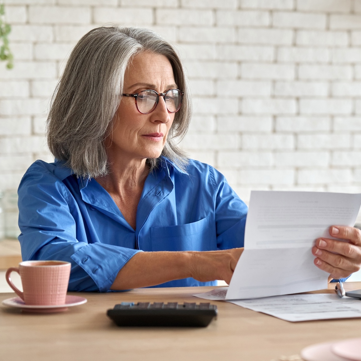 A middle-aged woman reviewing her finances