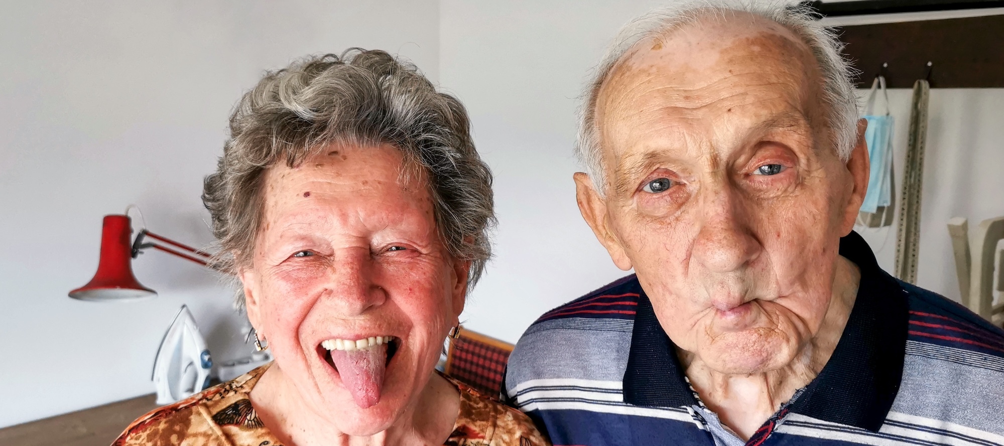A photo of an elderly couple making silly faces