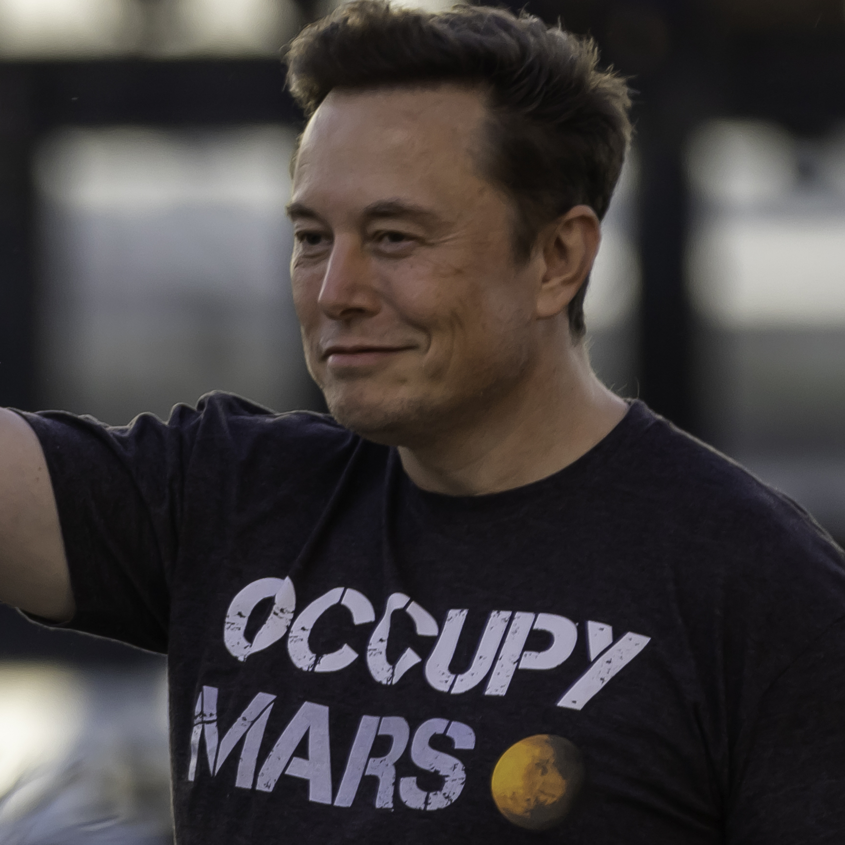 Elon Musk wears an “Occupy Mars” t-shirt.