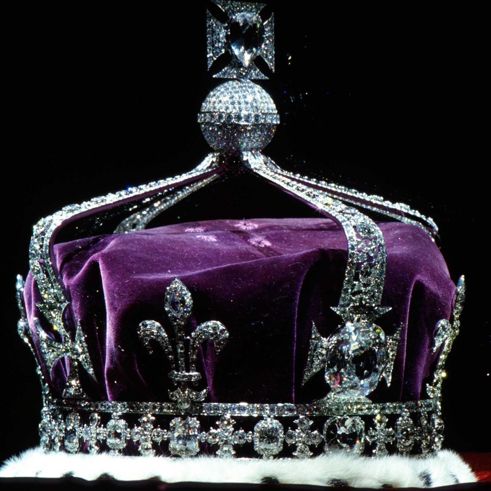 The Koh-i-Noor diamond is seen on the crown of Queen Elizabeth at left, and King Charles III shakes hands with NYC major Zohran Mamdani at right.