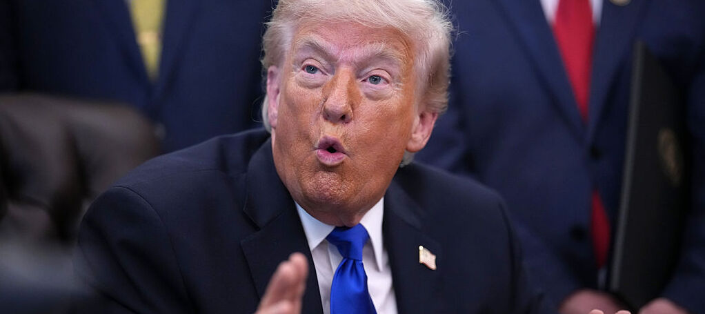 U.S. President Donald Trump answers questions during an executive order signing in the Oval Office.