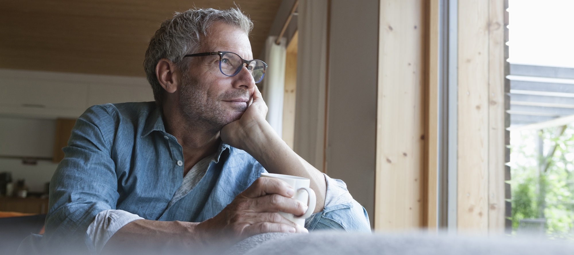 A photo of a middle-aged man thinking deeply