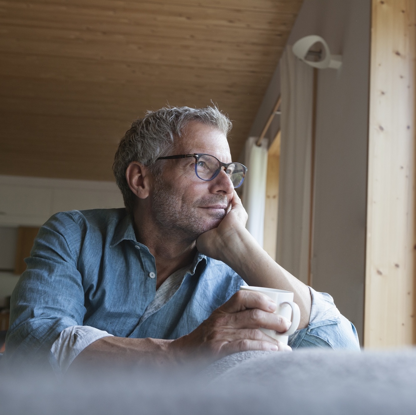 A photo of a middle-aged man thinking deeply