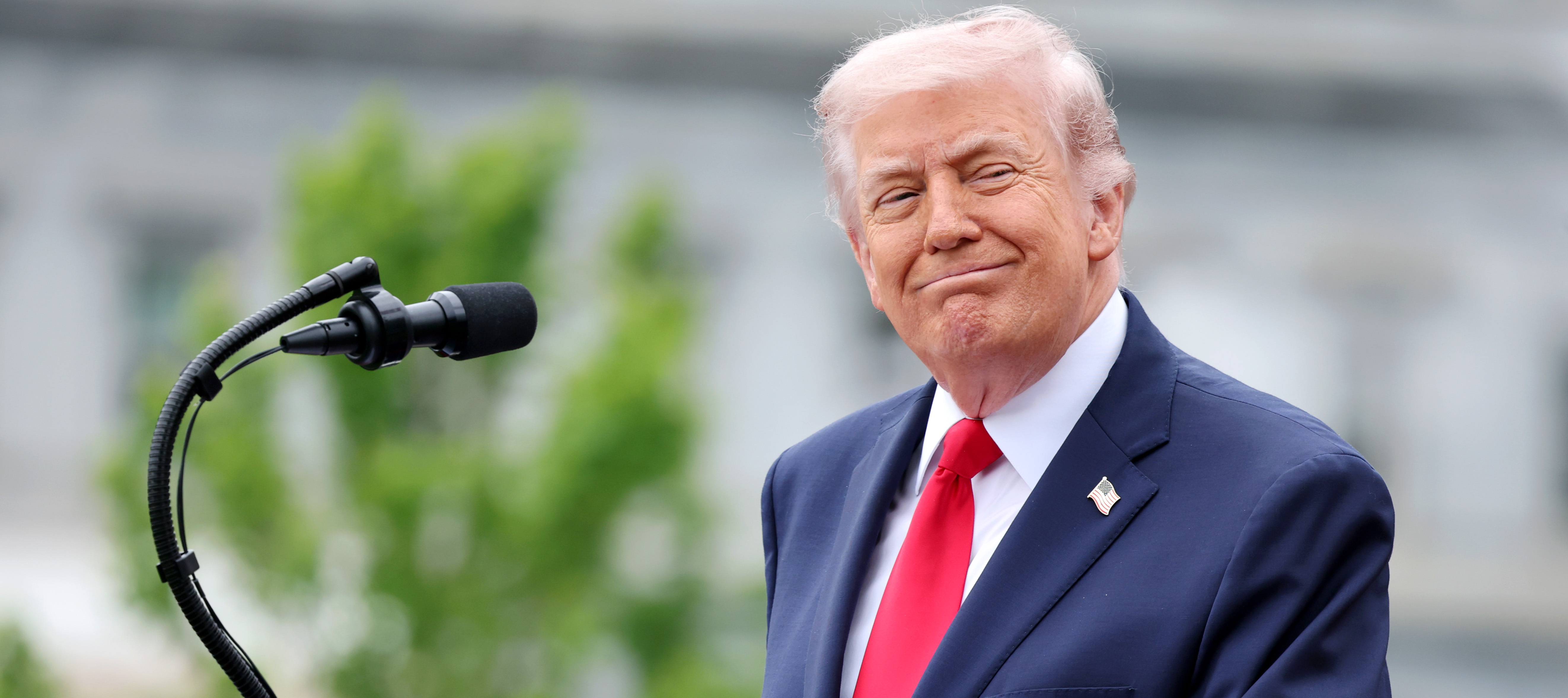 President Trump stands at the podium at a White House event in 2026.
