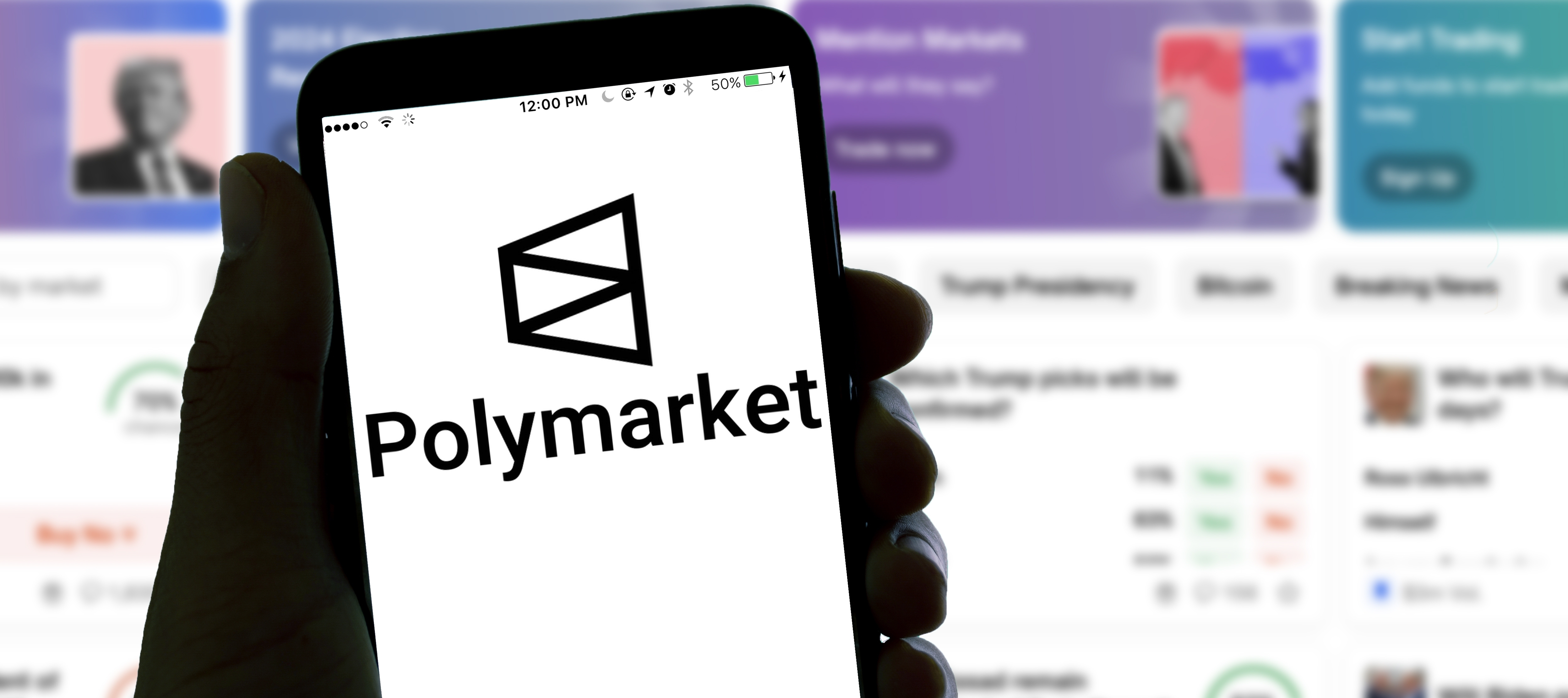 Polymarket logo appears on mobile screen with hand holding the phone.