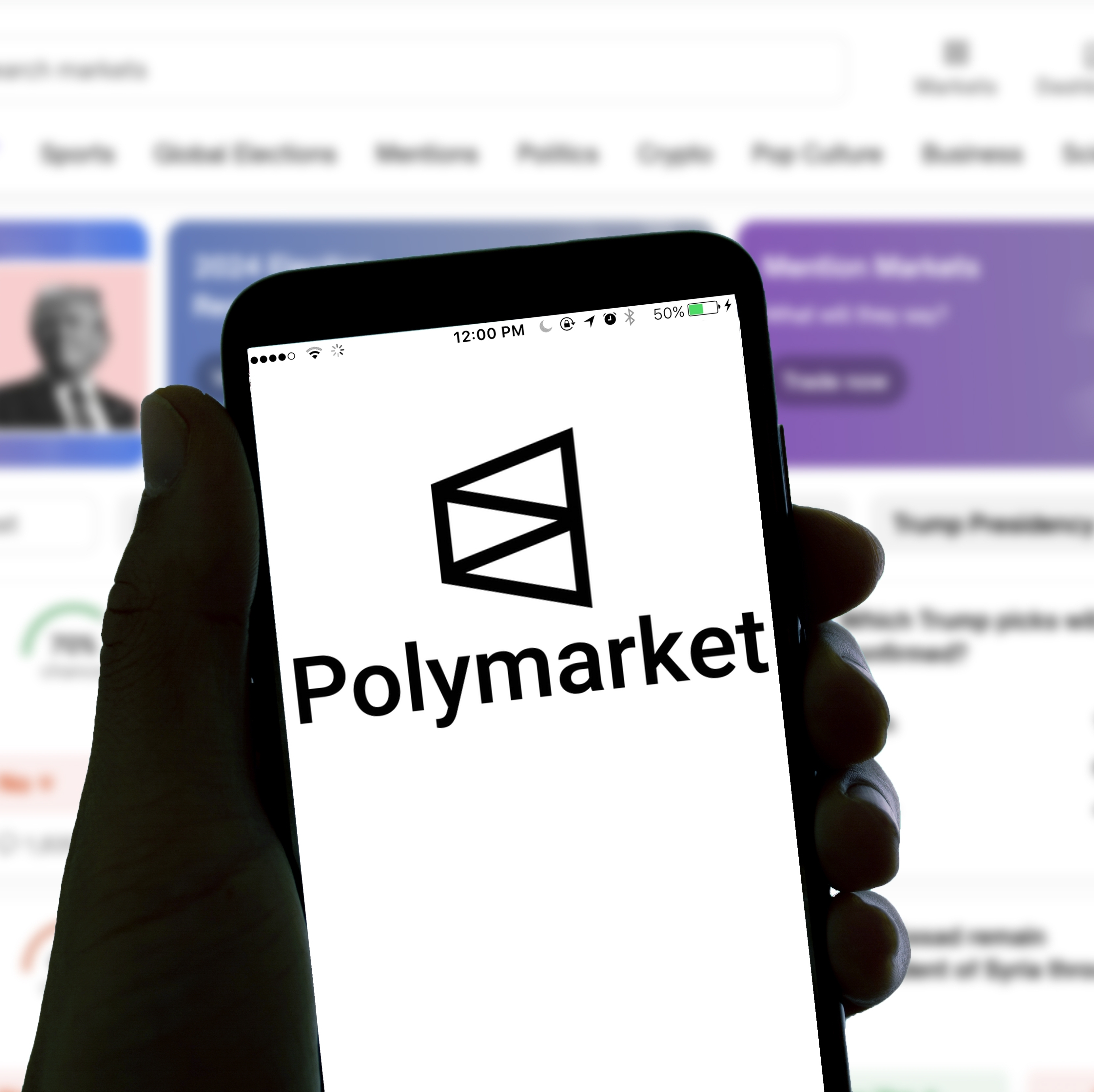Polymarket logo appears on mobile screen with hand holding the phone.