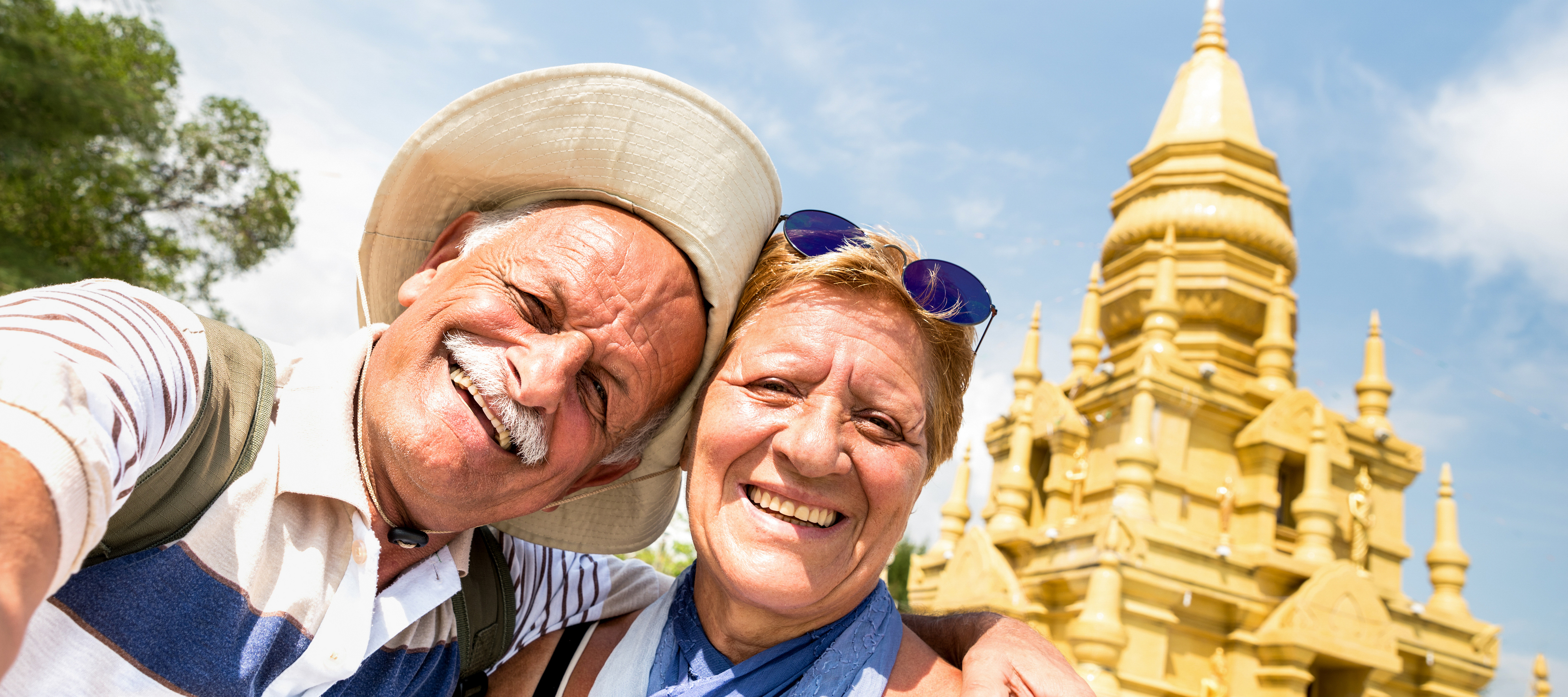 Senior couple taking a selfie at a temple in Ko Samui in Thailand.